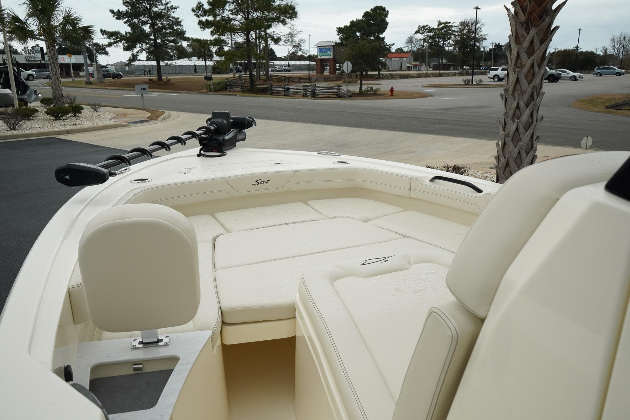 2025 Scout 261 XSS boat interior with seating and steering, parked outdoors.