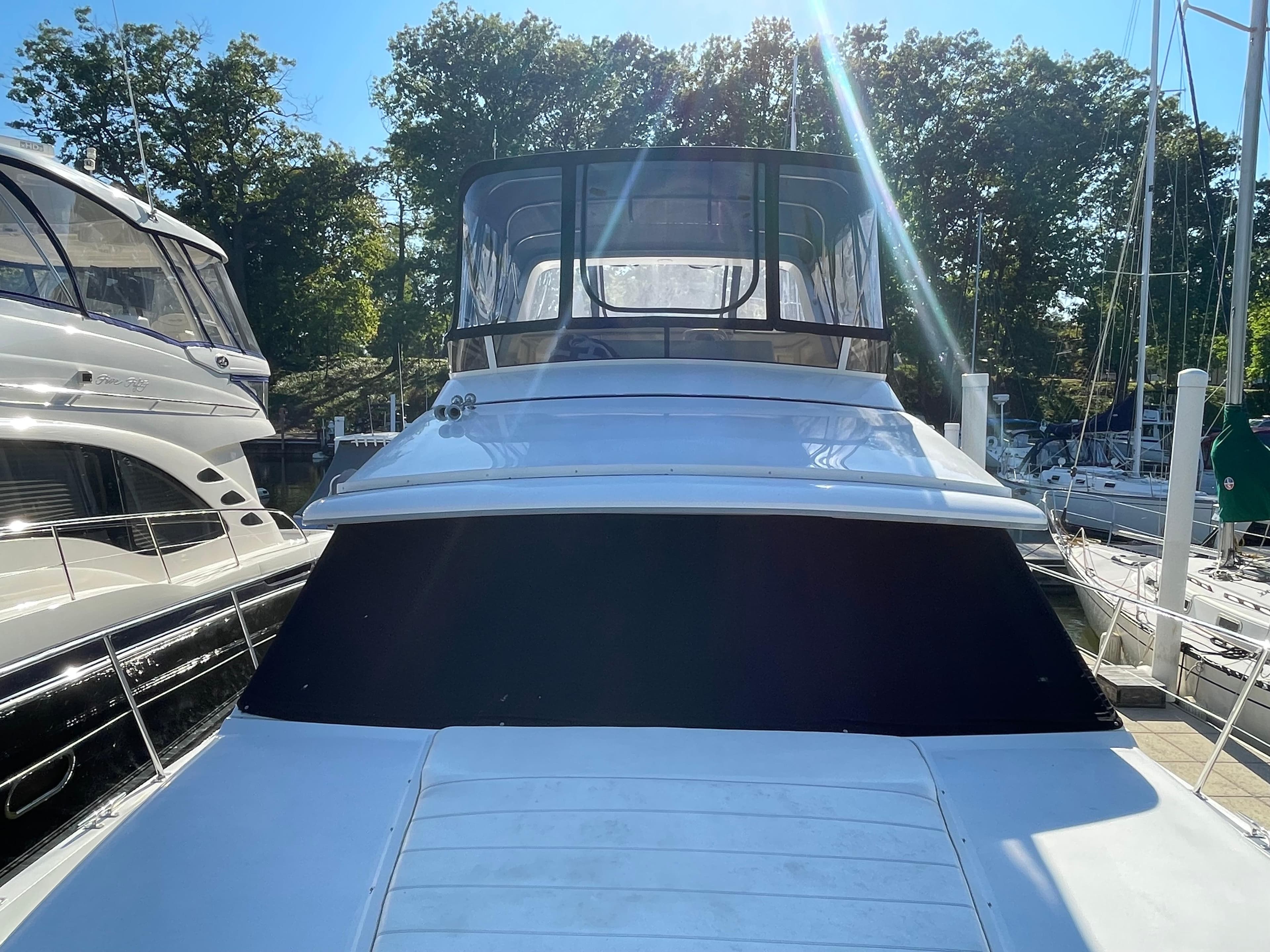 1998 Carver 445 Aft Cabin Motor Yacht docked in marina, sunny day.