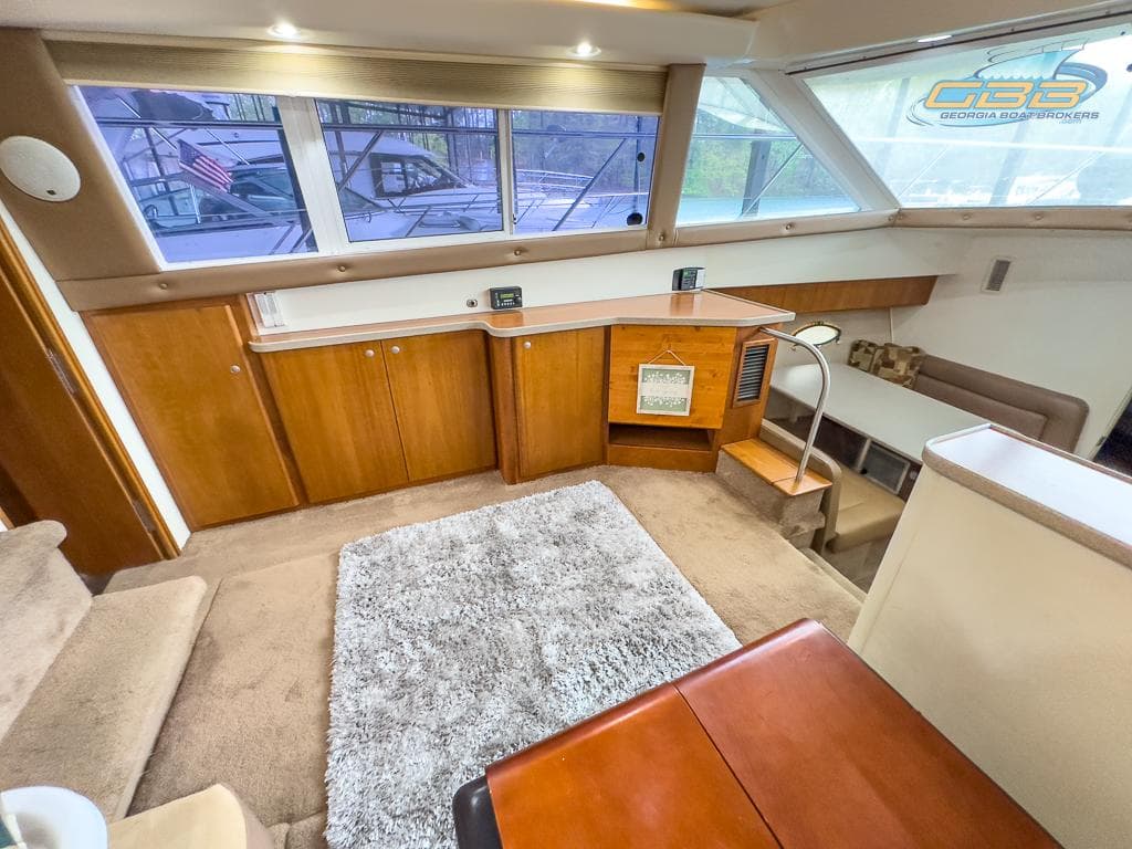 Interior of 1996 Silverton 442 Cockpit Motor Yacht with carpet and wooden furnishings.