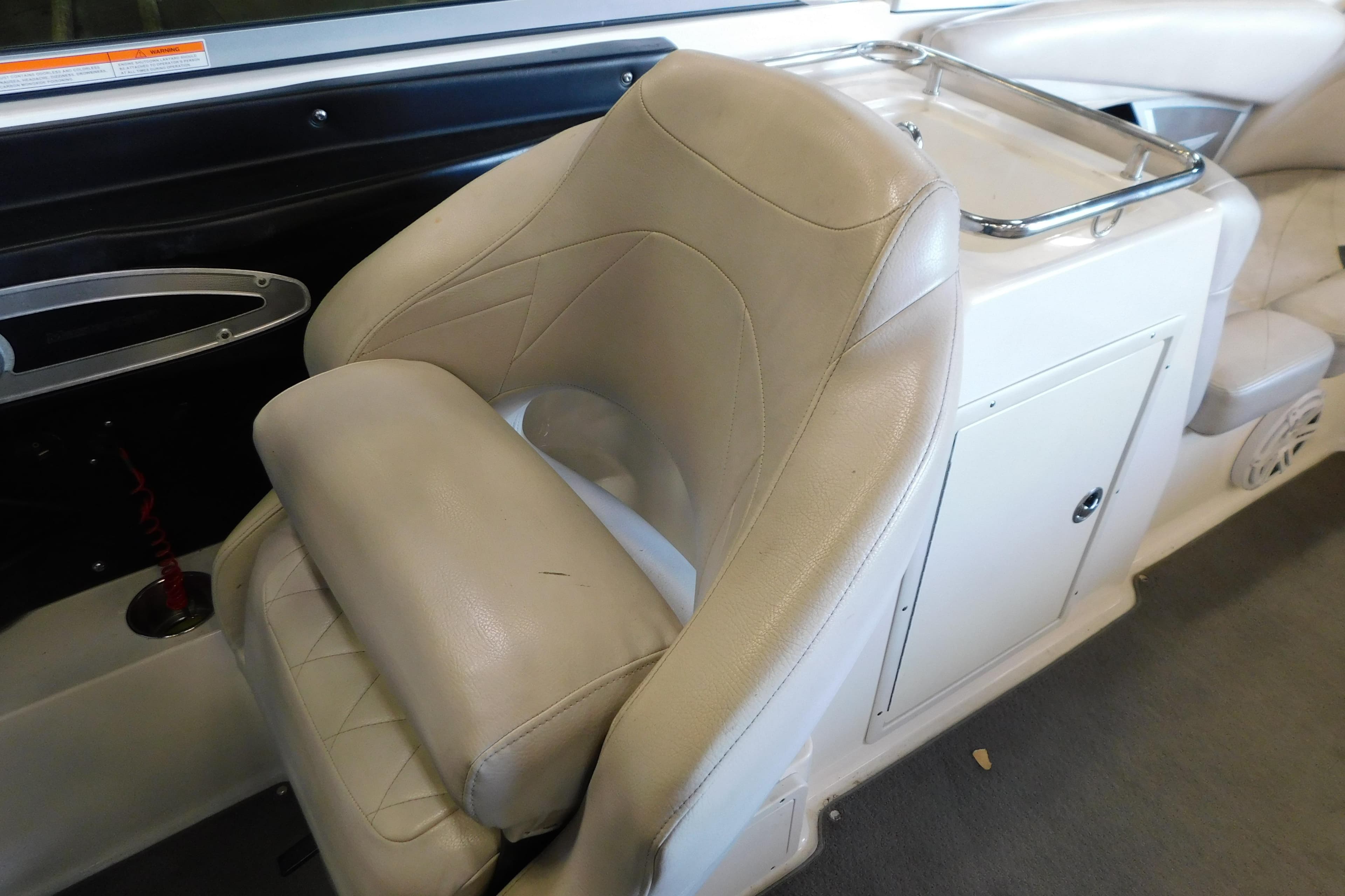 2009 MasterCraft X55 boat interior with beige leather seating and storage compartment.
