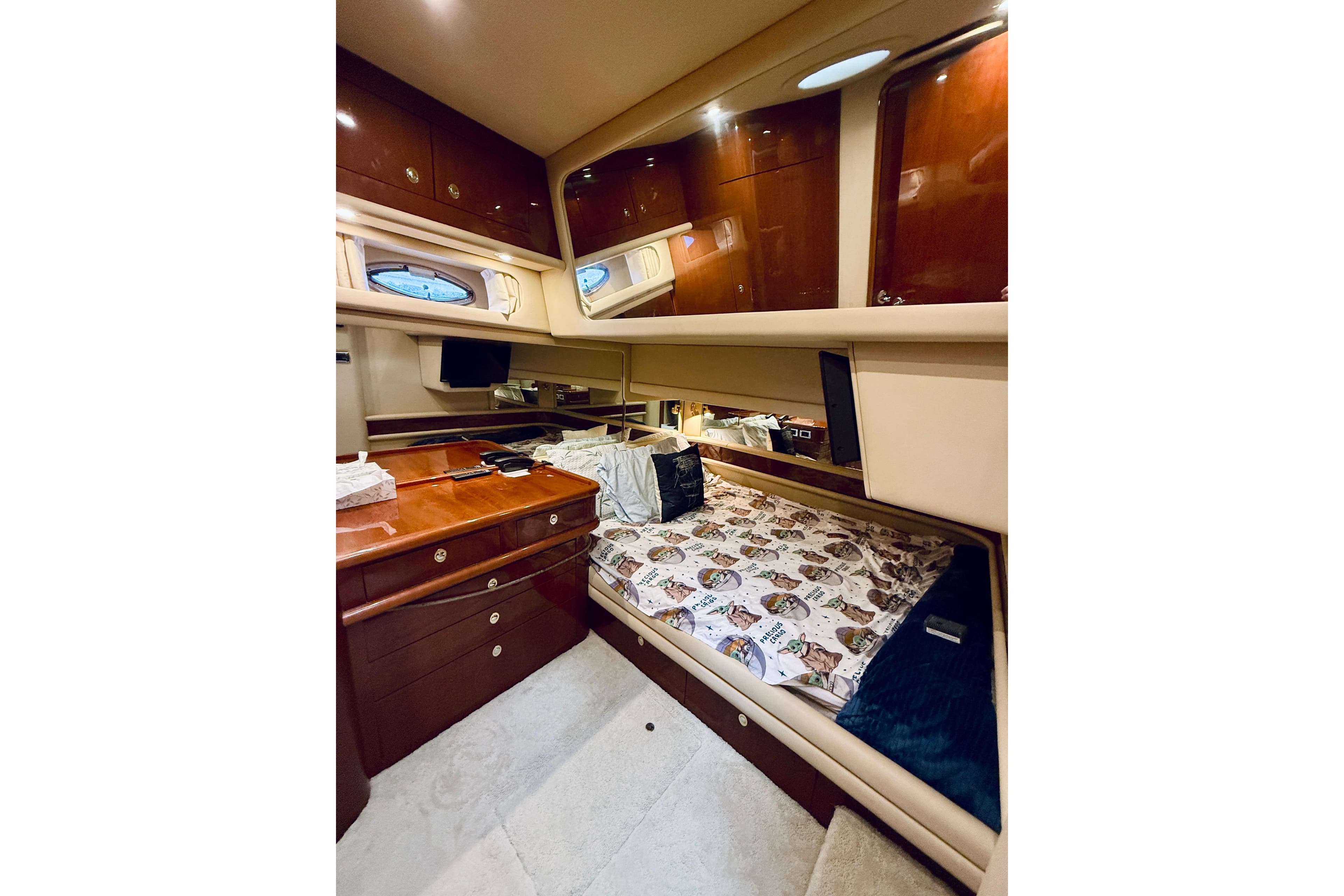 Luxurious cabin interior of 2003 Sea Ray 560 Sedan Bridge yacht with wood cabinetry.