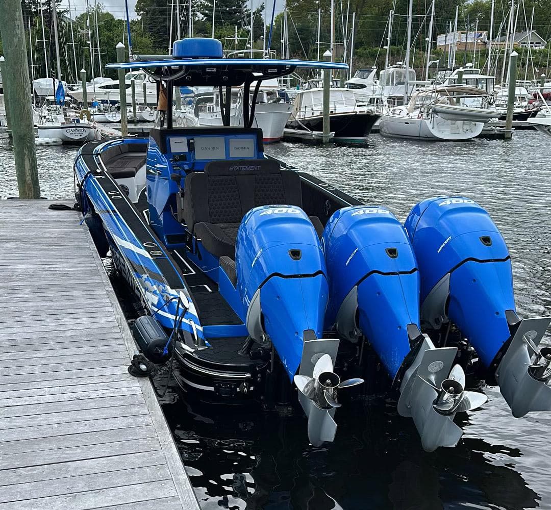 2021 Statement 380 Open boat with triple blue outboard engines docked at marina.
