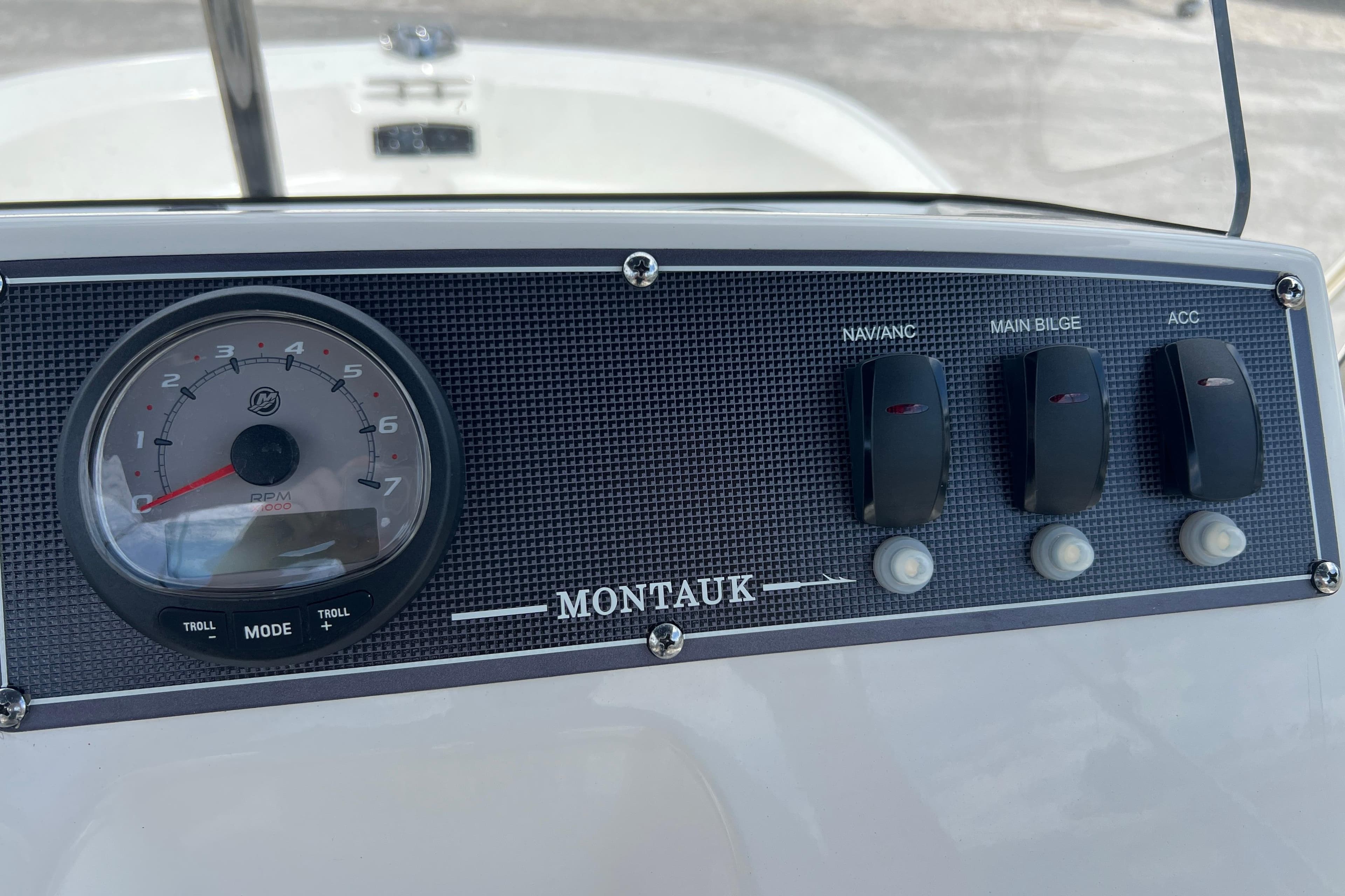Control panel of 2023 Boston Whaler 150 Montauk boat with RPM gauge and switches.