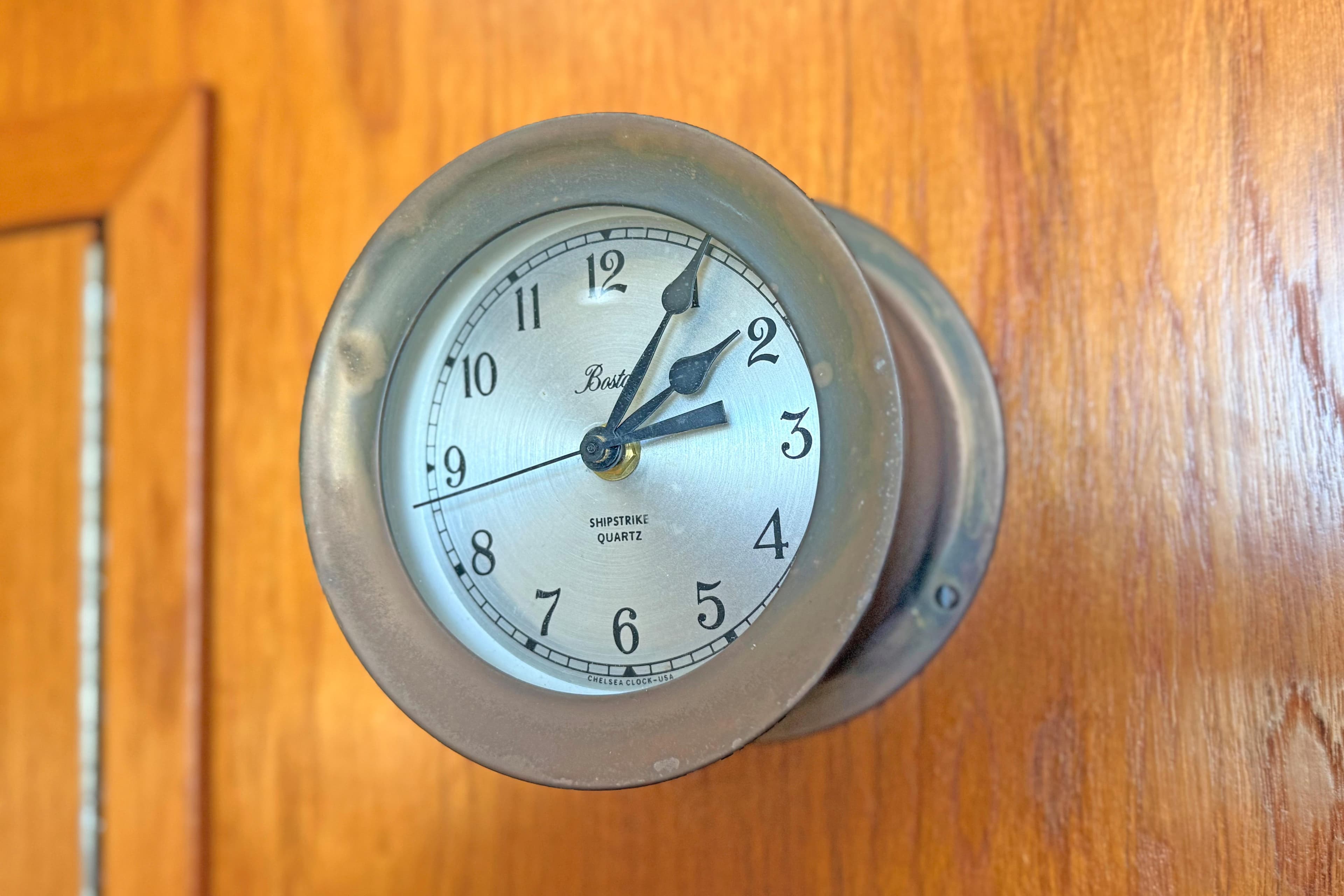 Vintage ship clock on Tiara 3700 Open Hardtop, 1996 model, mounted on wooden panel.