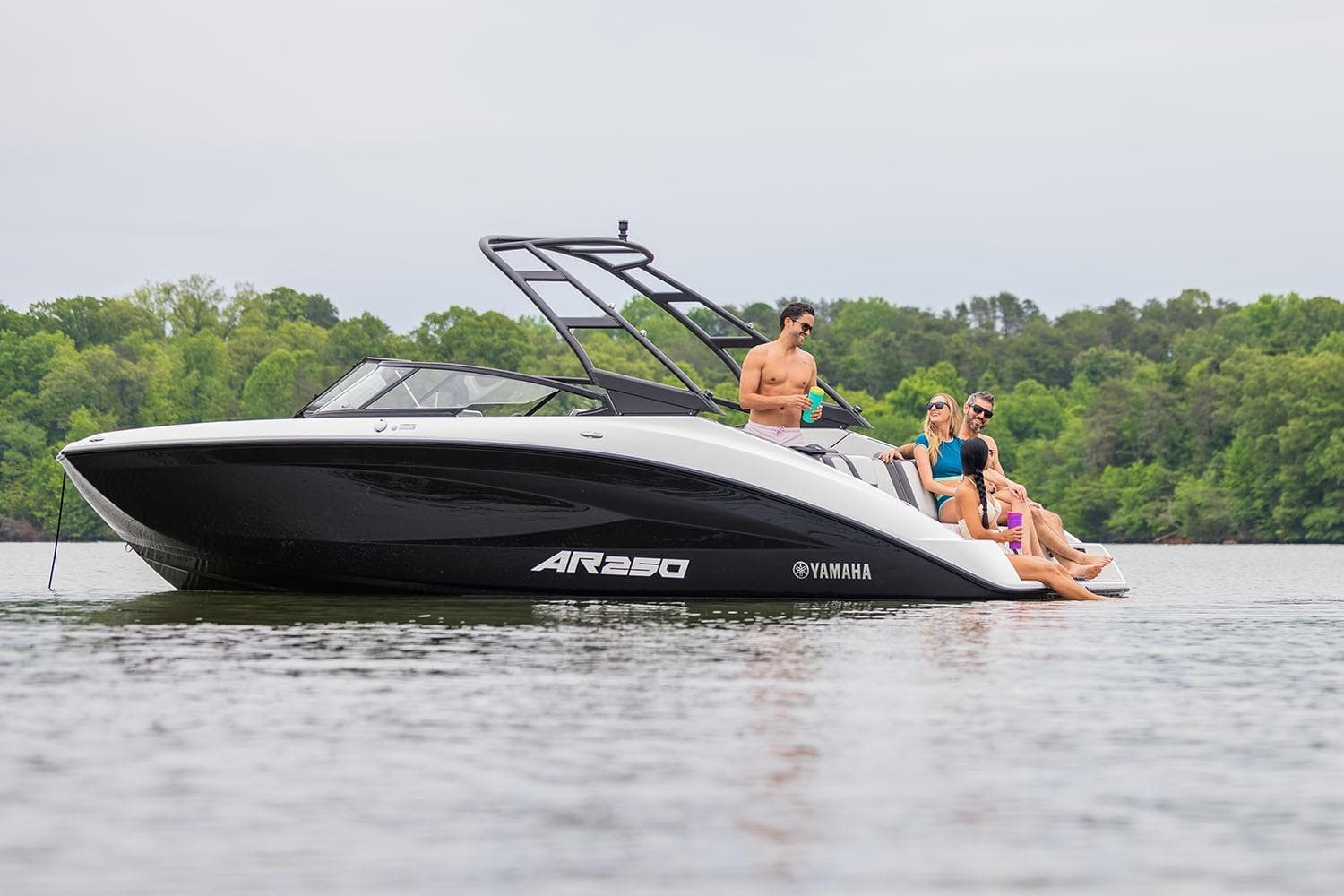 Manufacturer Provided Image: 2026 Yamaha Boats AR250 on a lake with people relaxing onboard.