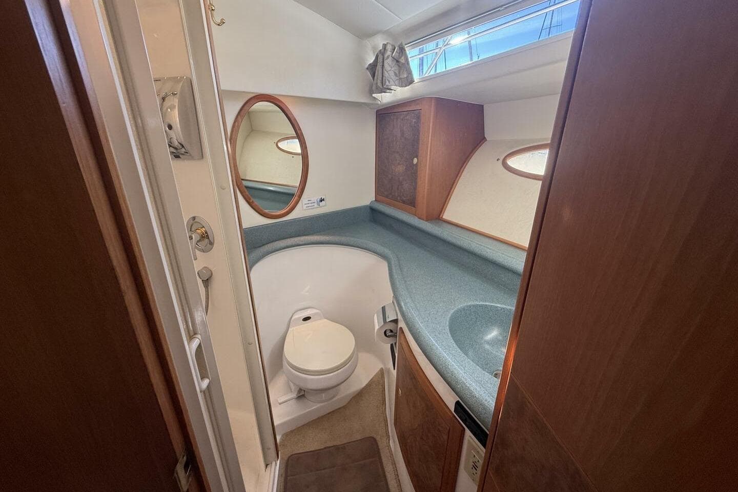 Bathroom interior of 2000 Royal Pacific 476 Sport Cruiser with sink and toilet.