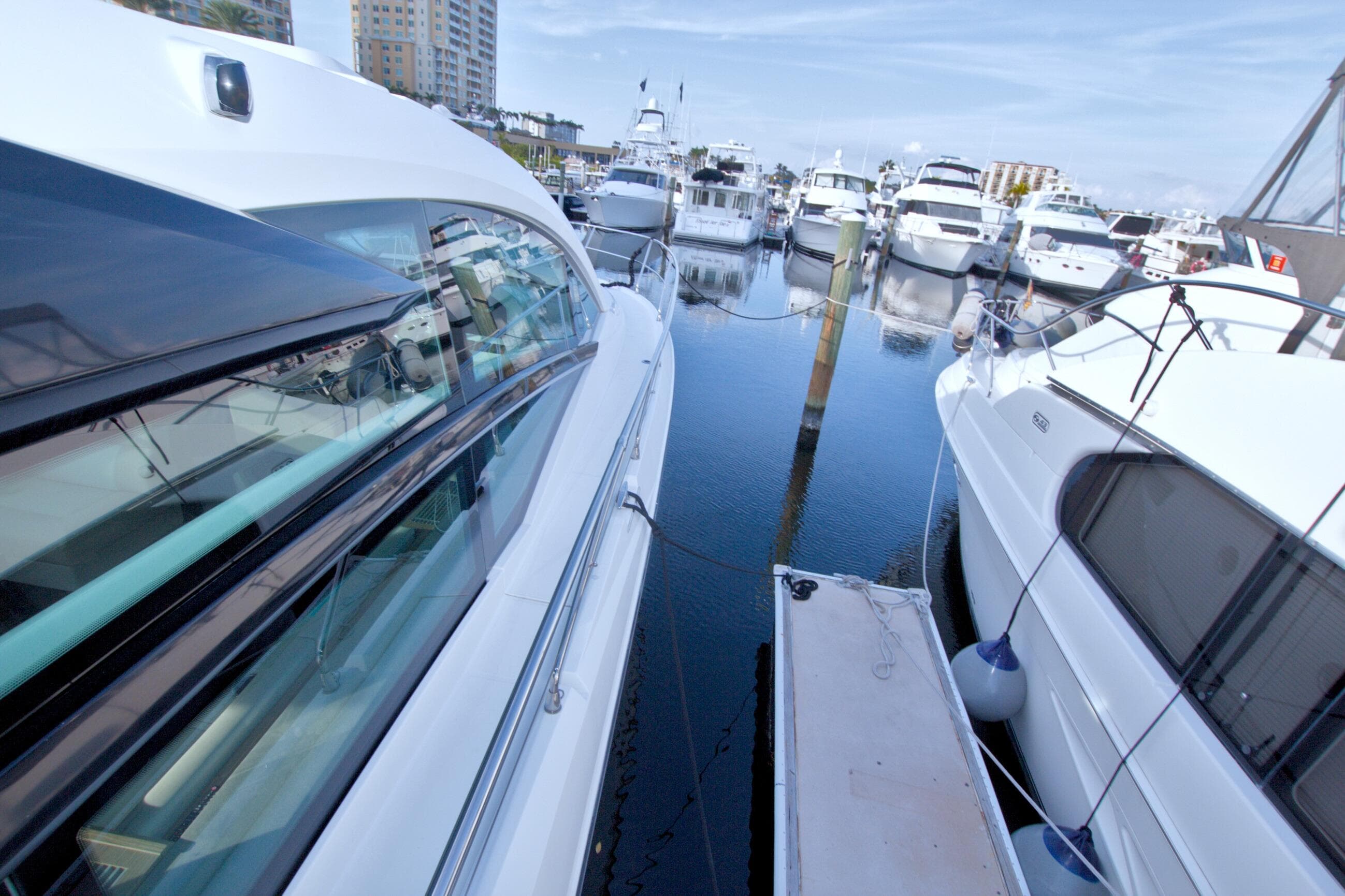 2019 Beneteau Gran Turismo 50 yacht docked in a marina, surrounded by other boats.