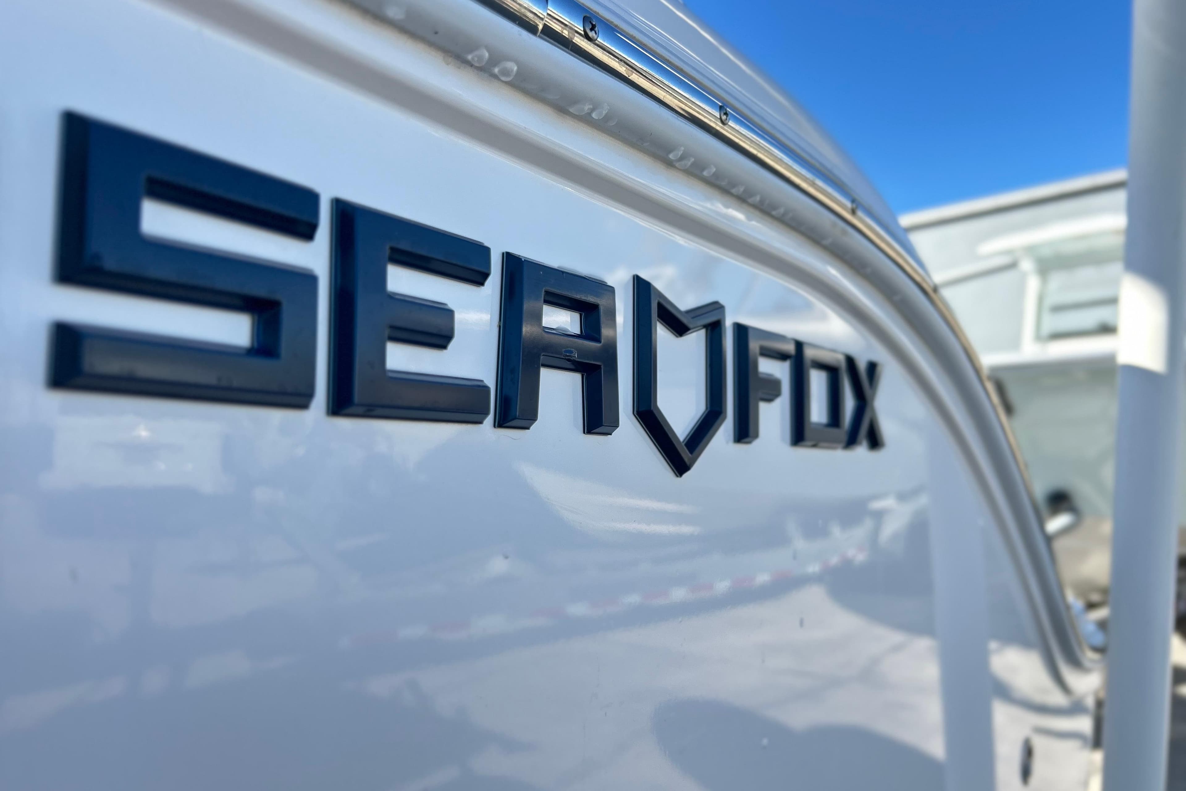 2024 Sea Fox 268 Commander boat logo on white hull, close-up view.