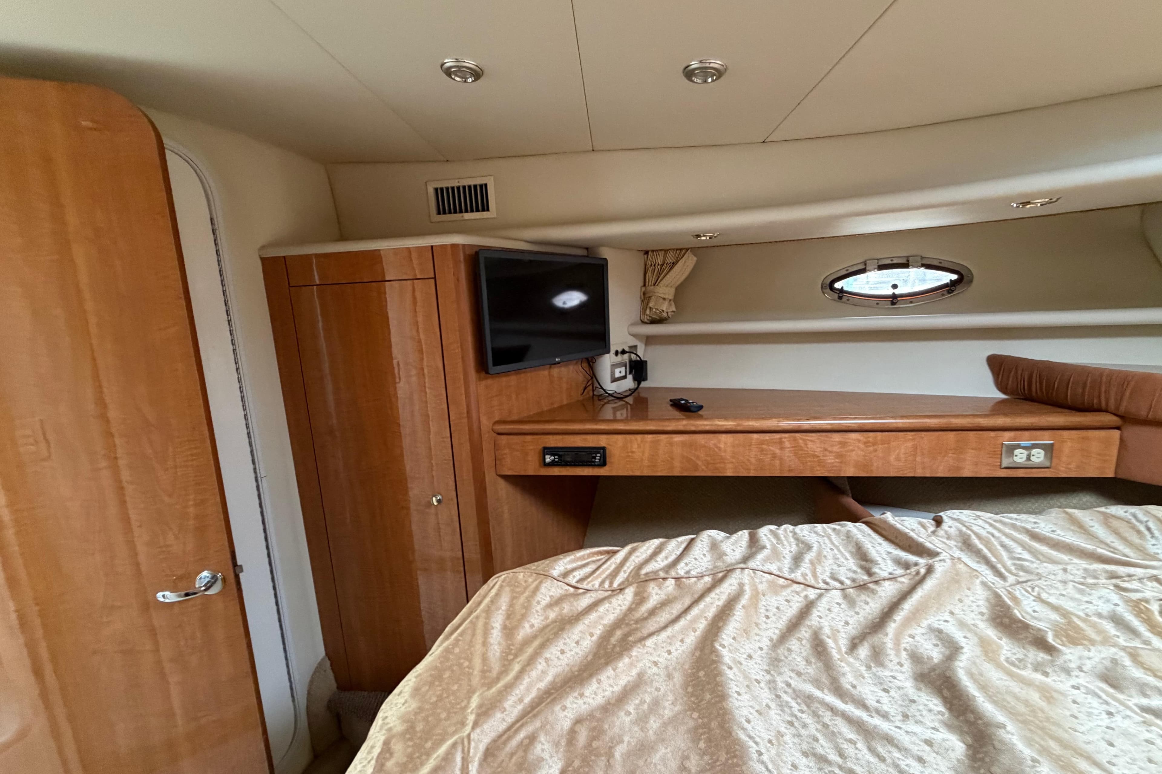 Luxurious cabin interior of 2001 Maxum 4600 SCB Limited Edition yacht with wood finishes.