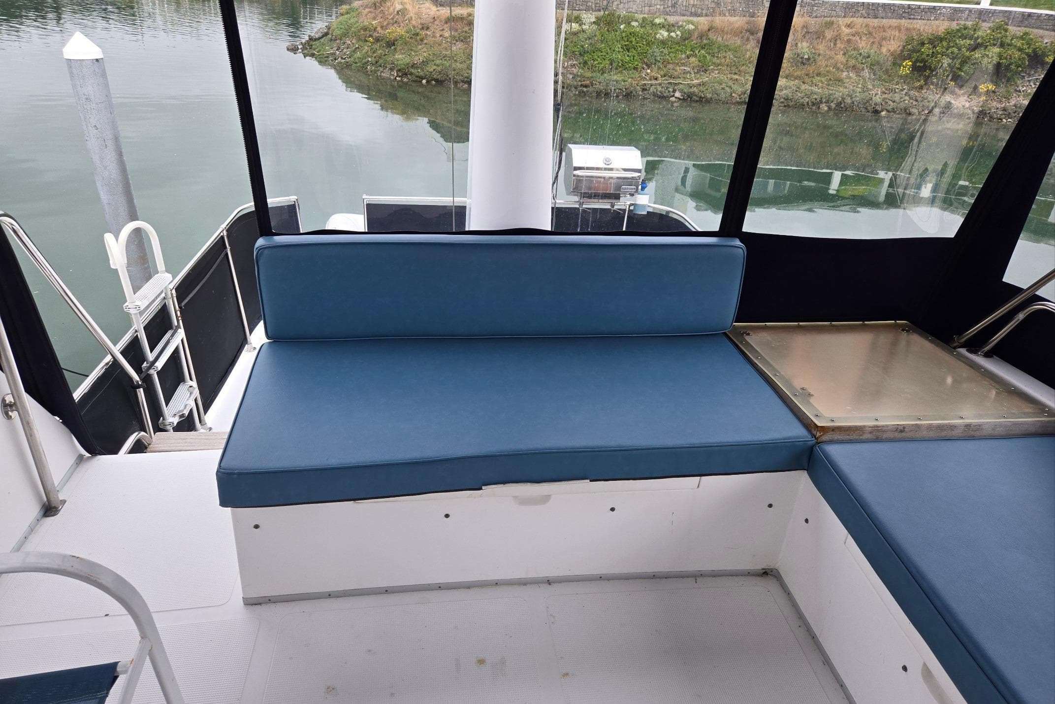 1993 Ocean Alexander 423 Classicco yacht interior with blue seating and water view.