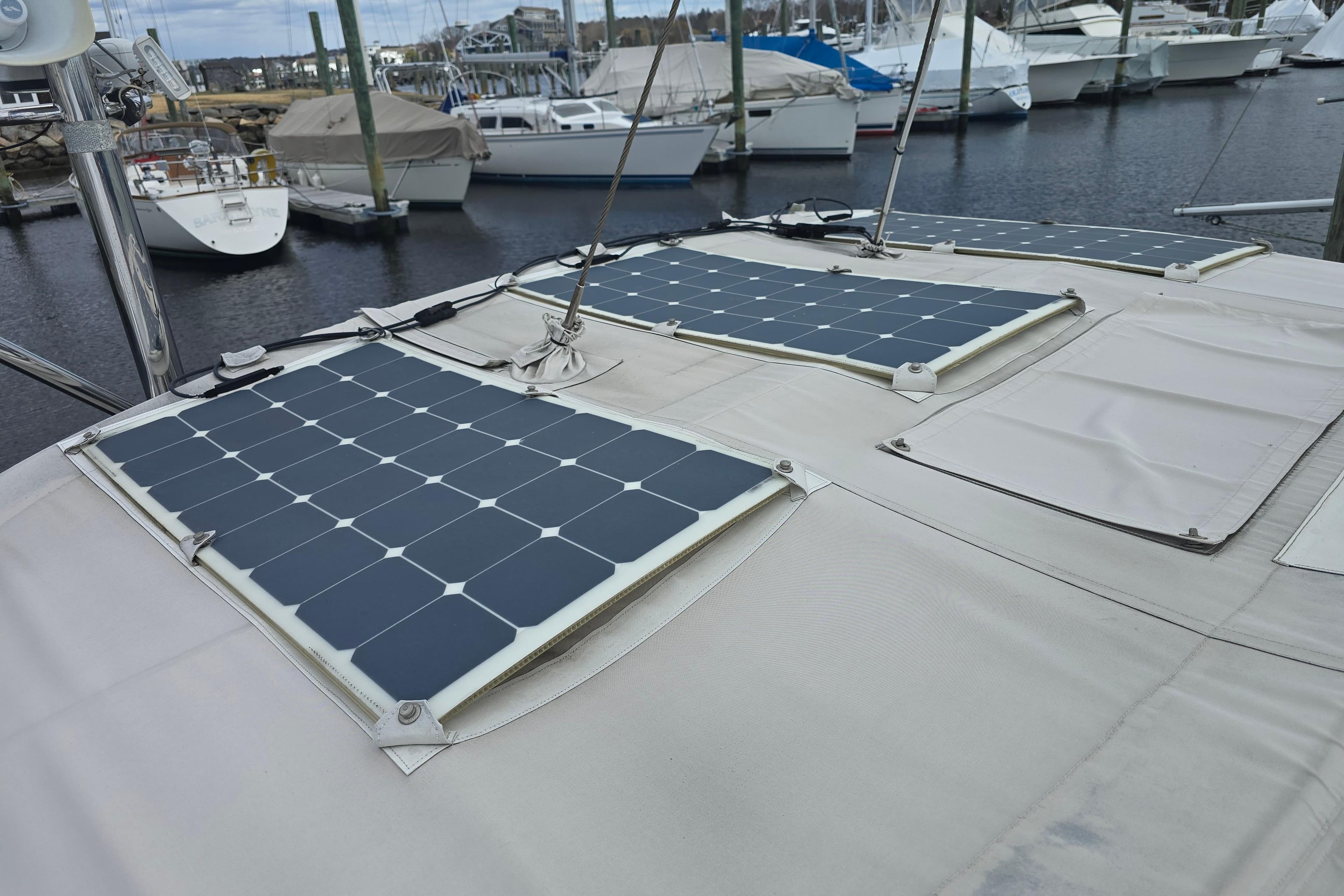Solar panels on a 2006 Outbound 44 sailboat docked at a marina.