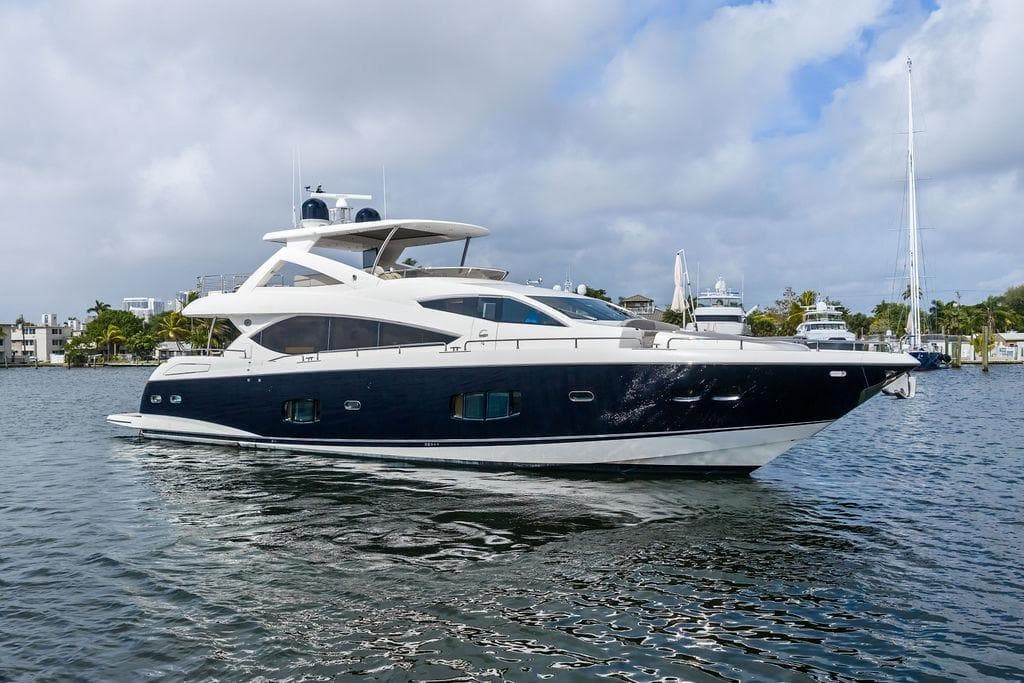 Luxurious 2012 Sunseeker 88 Yacht cruising on a serene waterway.