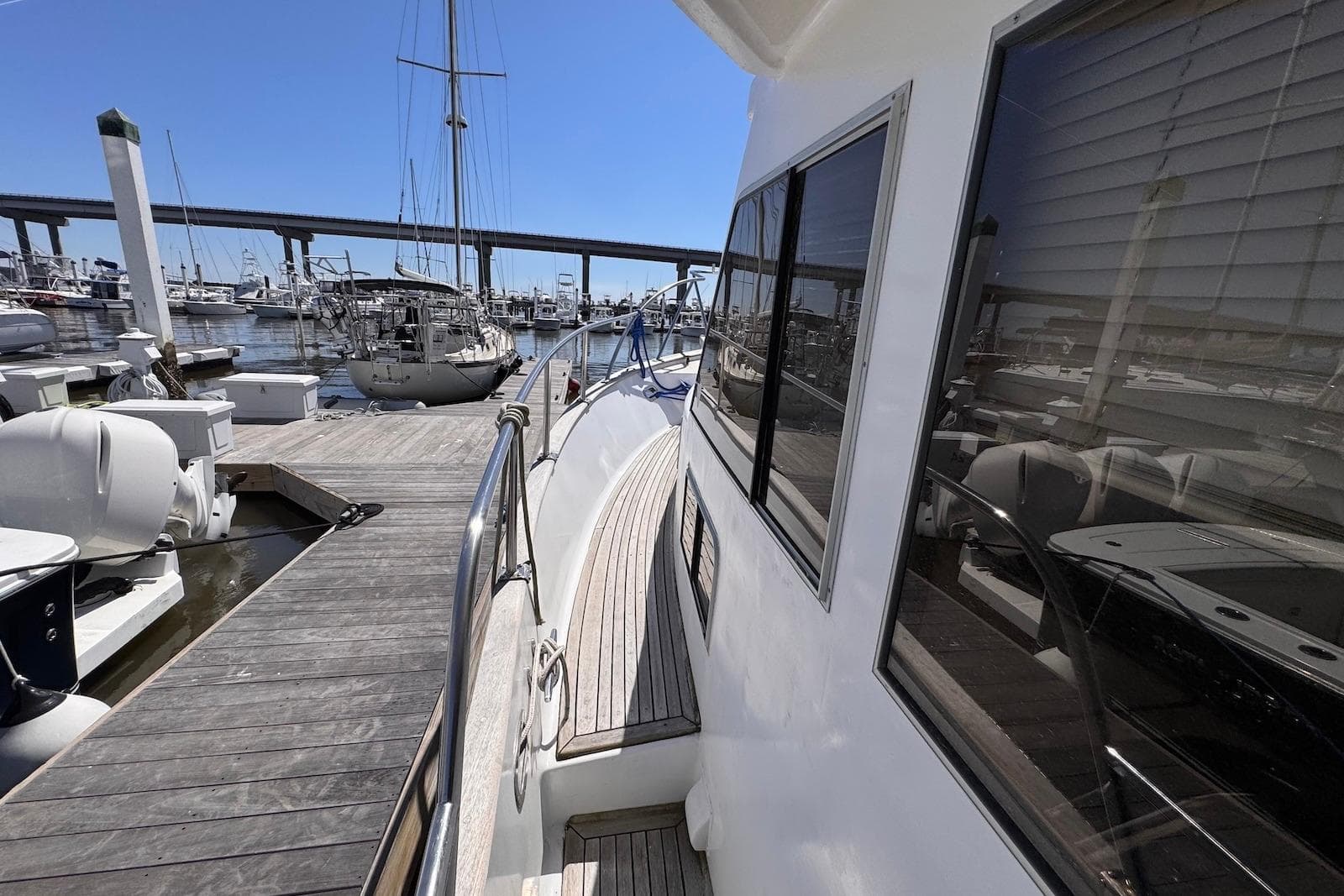 1995 Island Gypsy Eurosedan 32 docked at marina, showcasing sleek design and wooden deck.