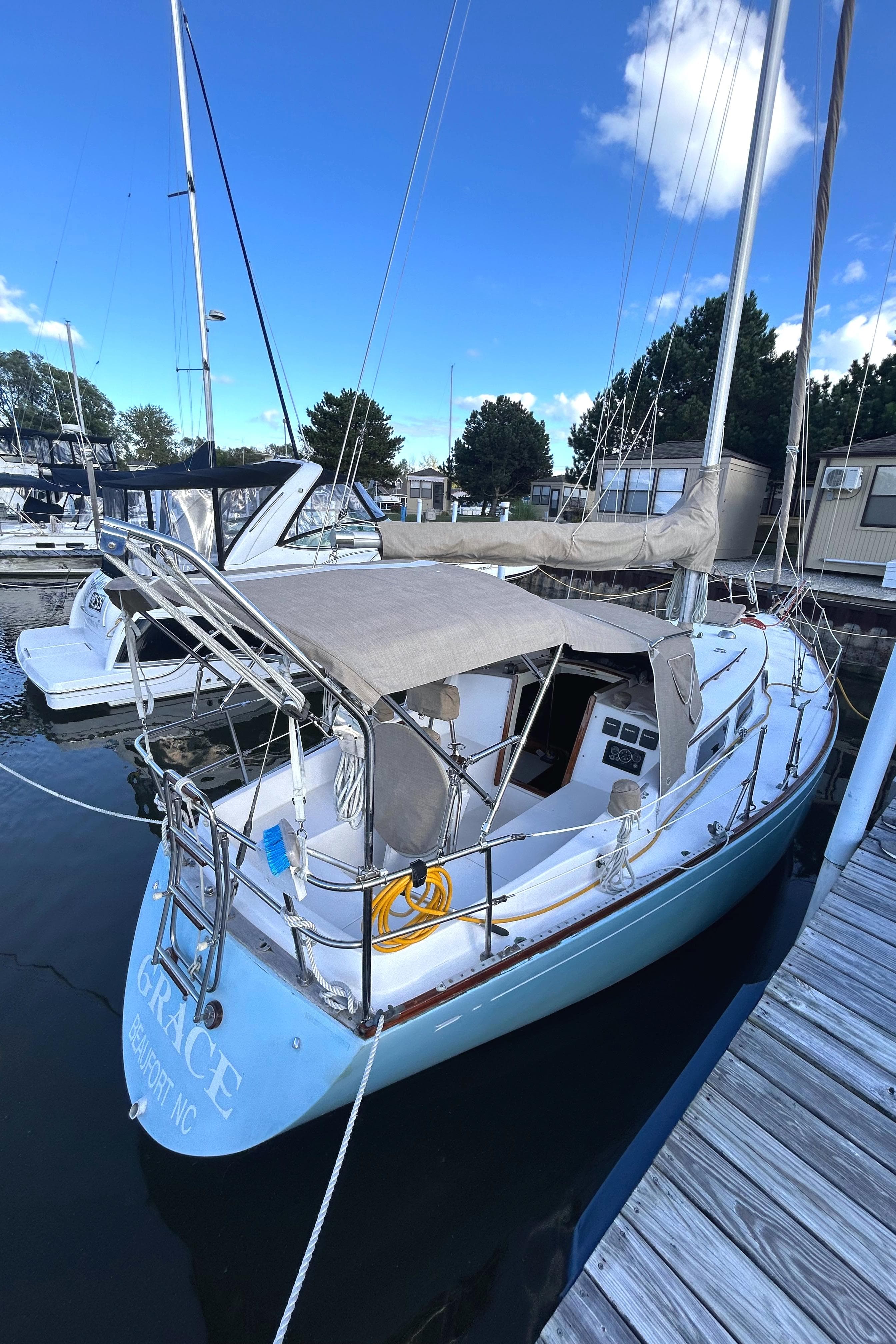 1980 Bristol 35.5 sailboat docked at marina under clear blue sky.
