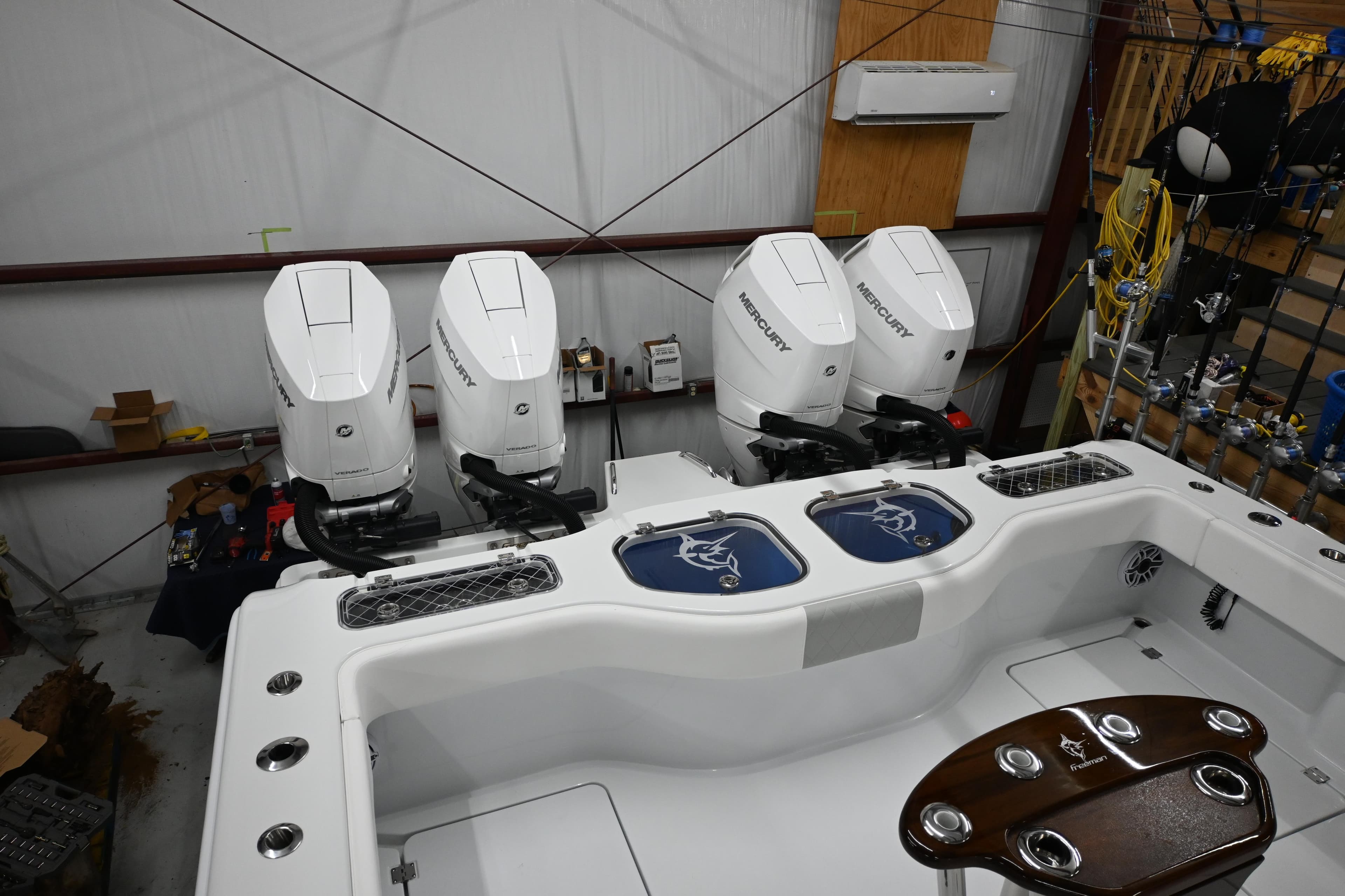 2024 Freeman 43 boat with four powerful outboard engines in a spacious indoor setting.