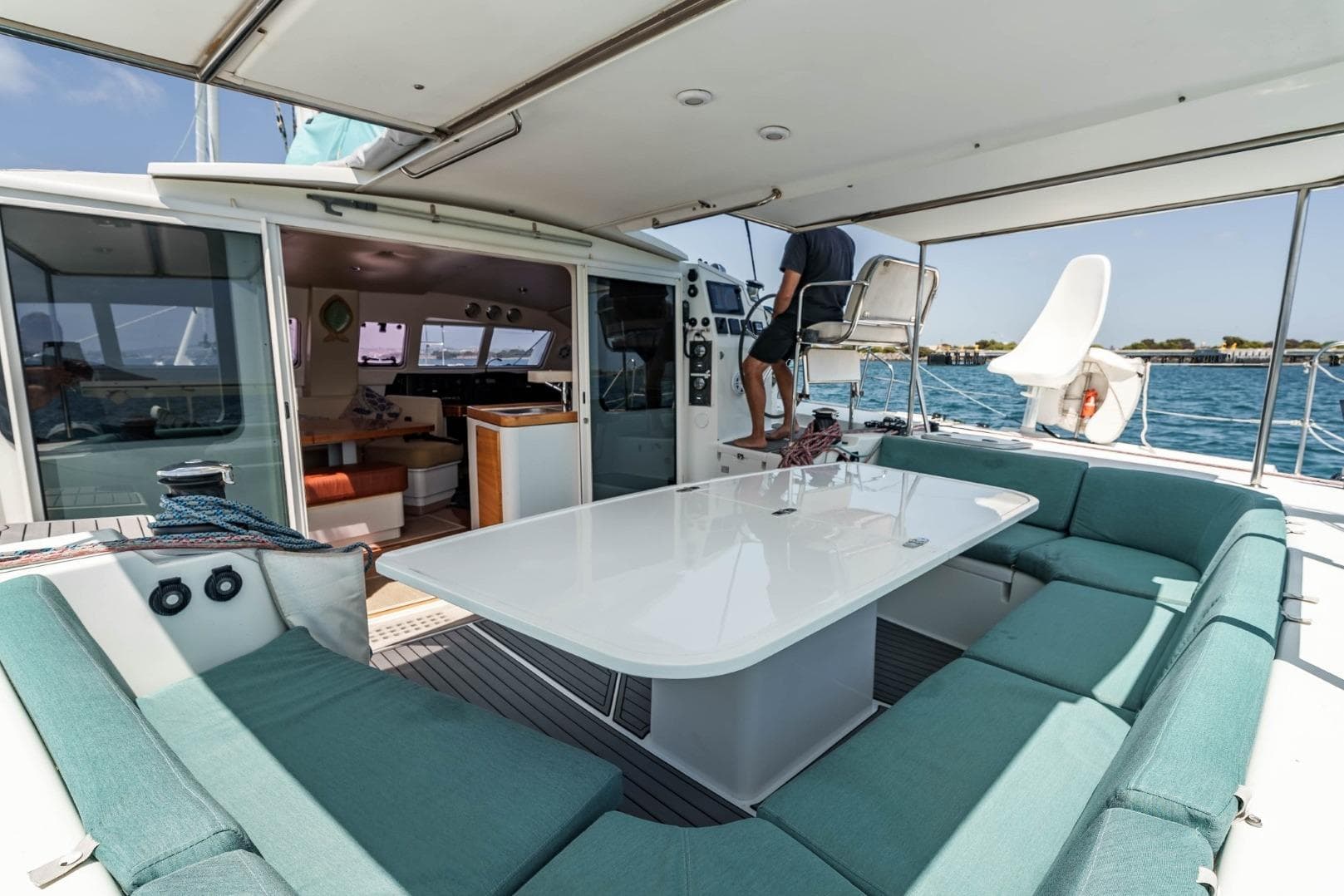 Spacious deck of 2012 Outremer 49 catamaran with seating and ocean view.