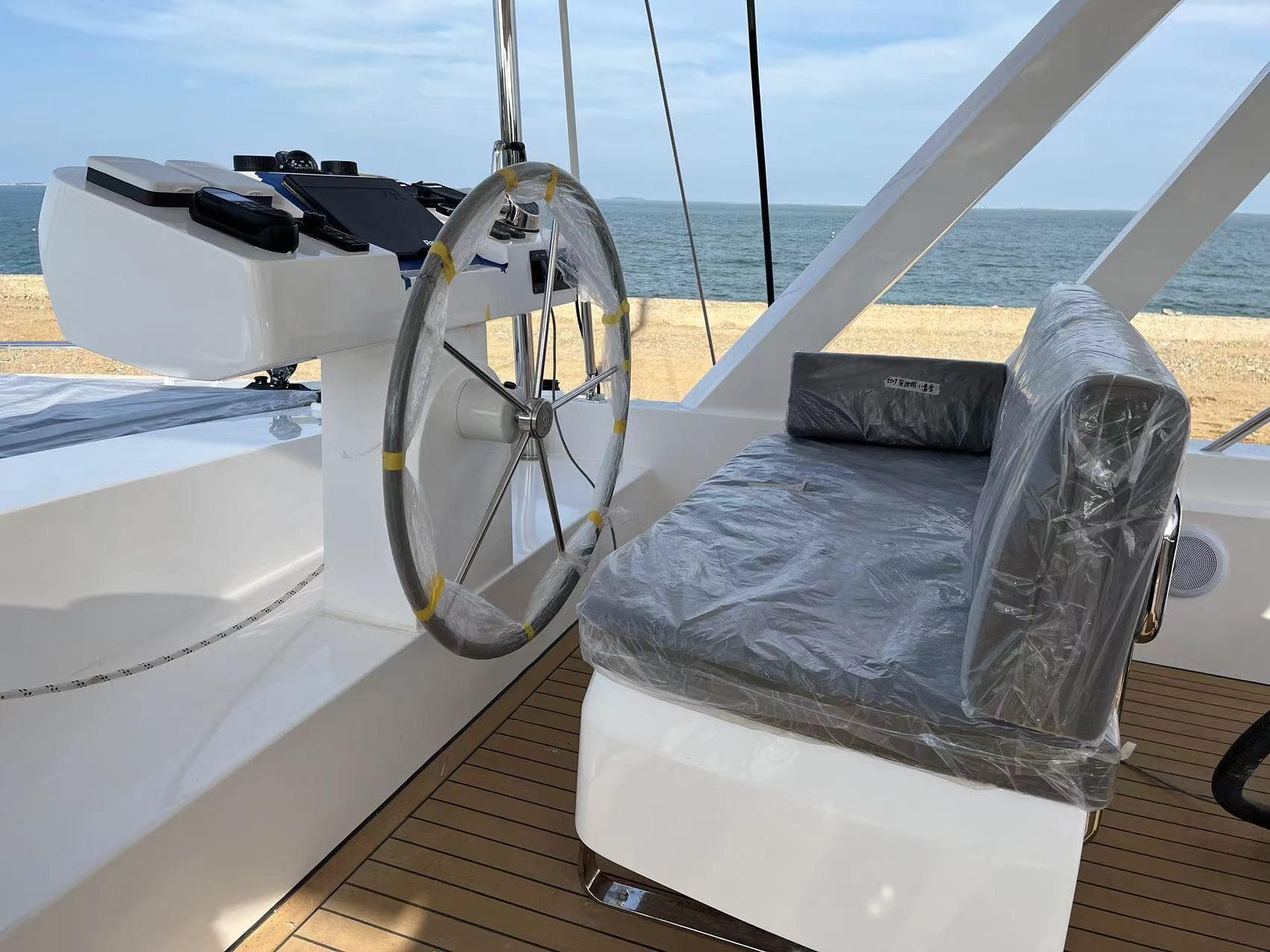 Mazarin 55 Catamaran 2023, helm station with seat, ocean view.