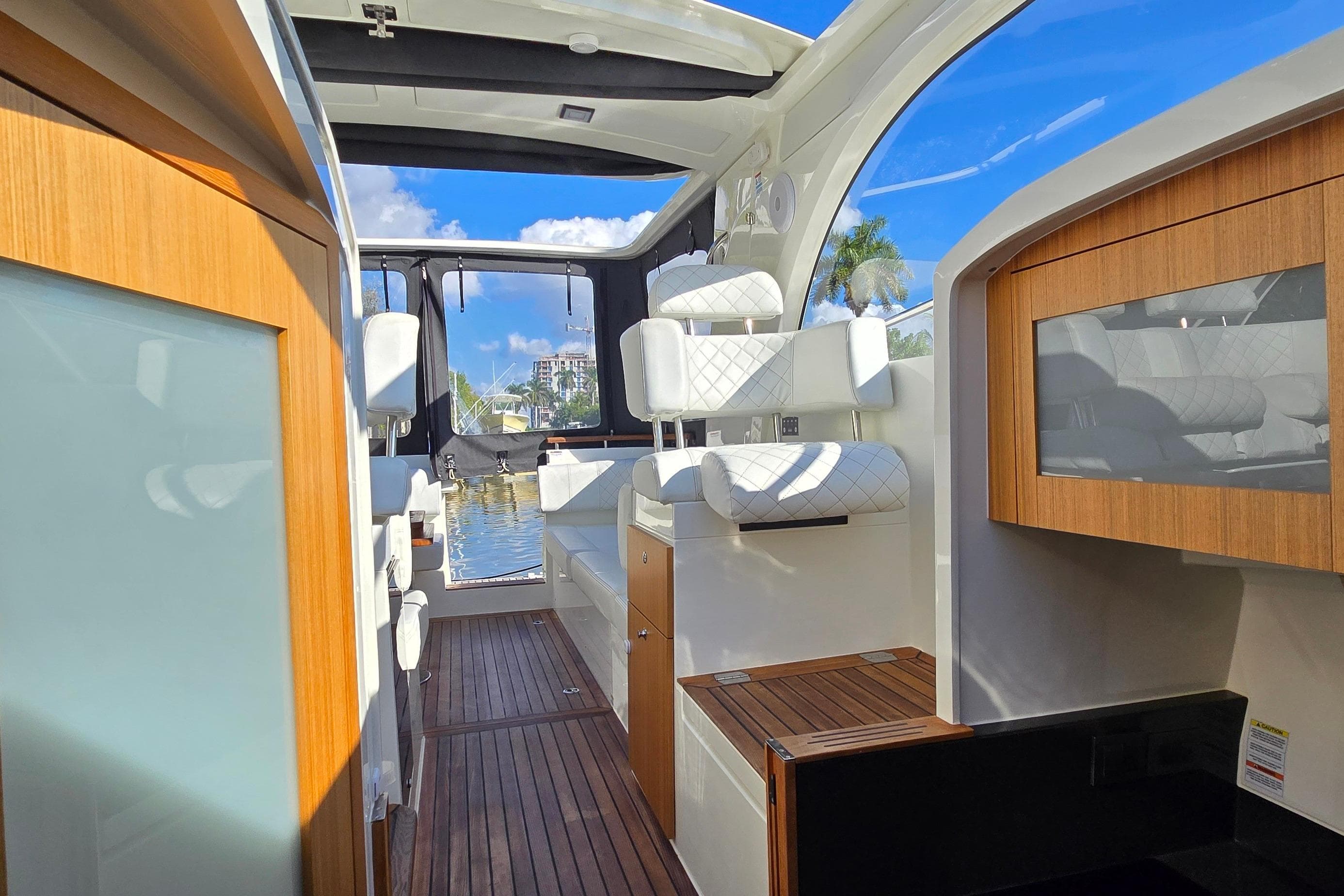 2025 Marex 310 Sun Cruiser interior with modern seating and wooden accents.