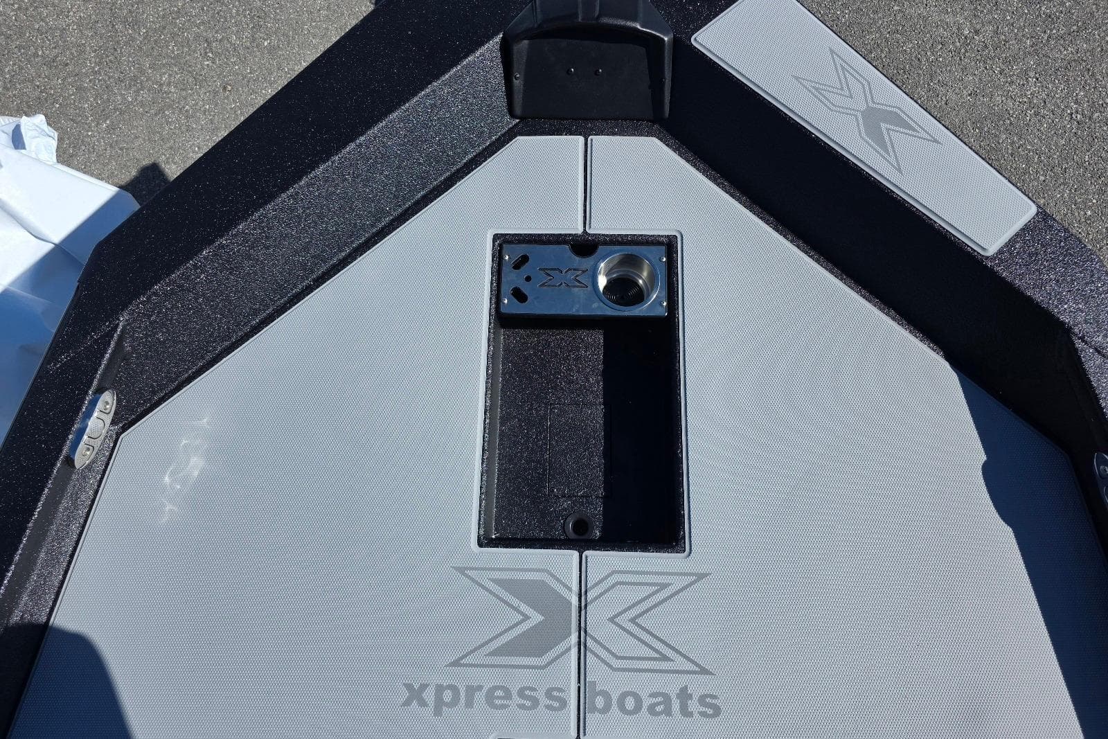 2026 Xpress H20 Bass boat deck with logo and storage compartment.