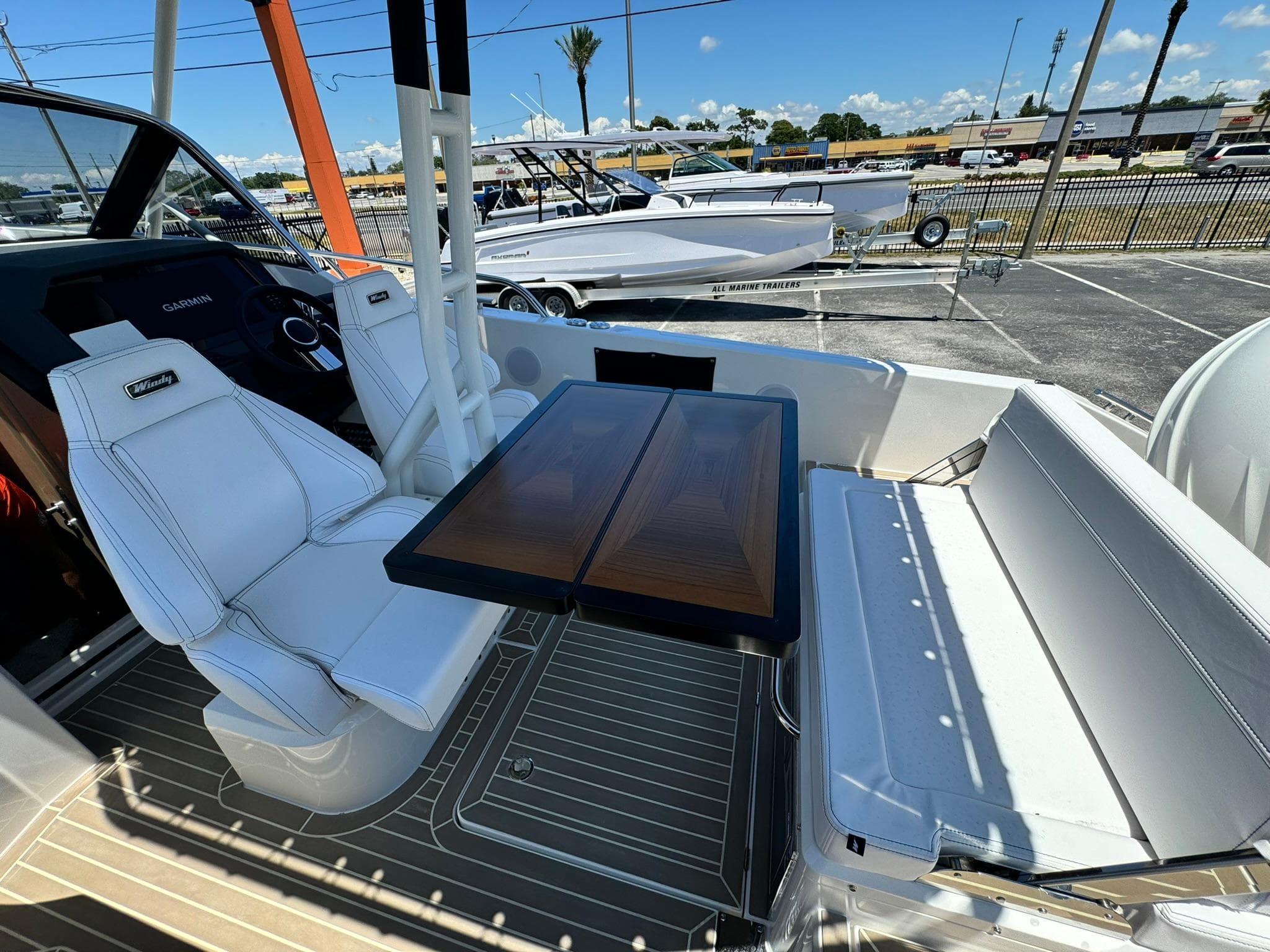 2024 Windy SR28 CC boat interior with white seating and wooden table.