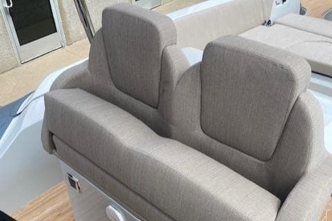 2024 SACS Strider 900 boat with beige cushioned seating.