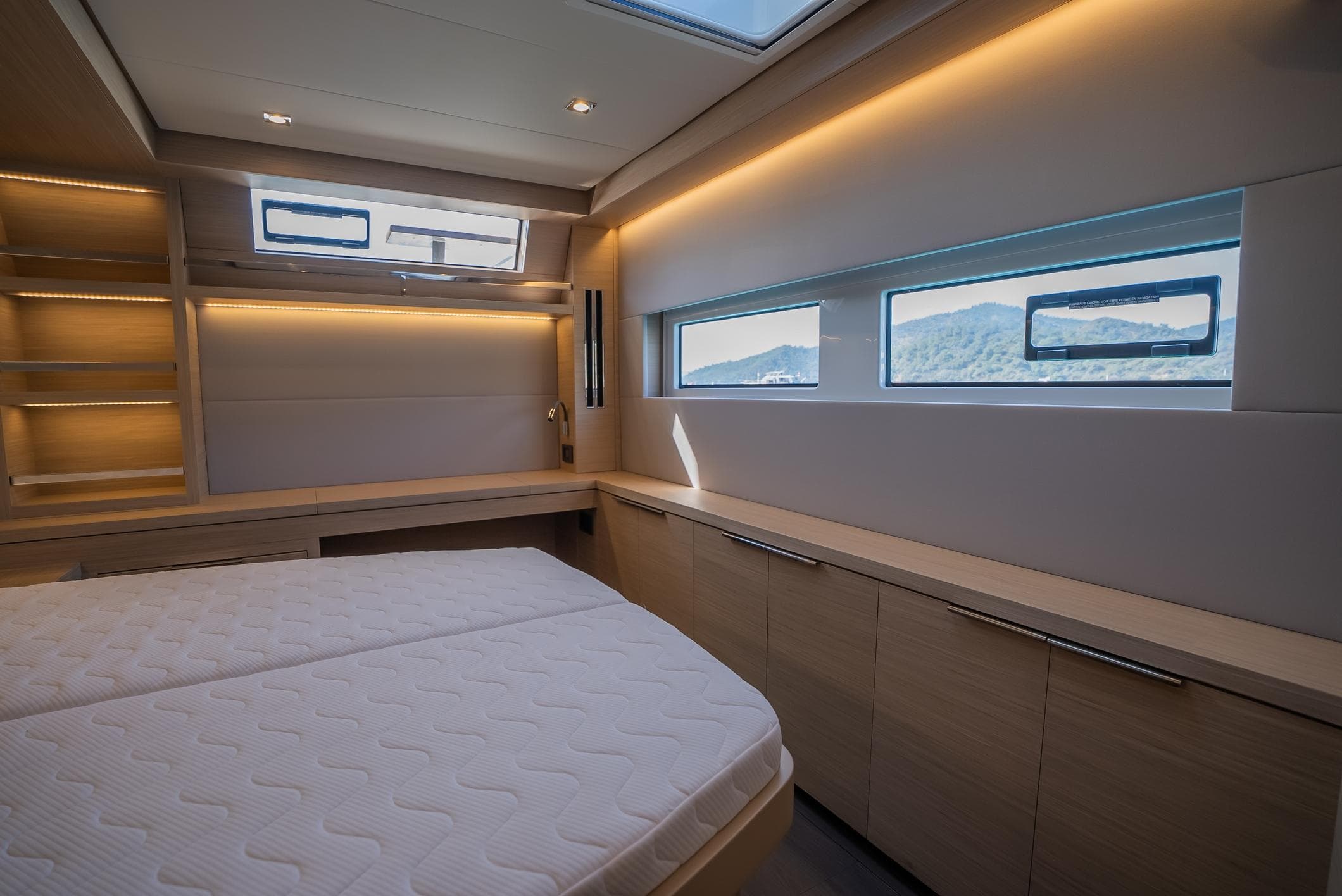 Luxurious interior of 2024 Lagoon 55 yacht cabin with modern design and ample natural light.
