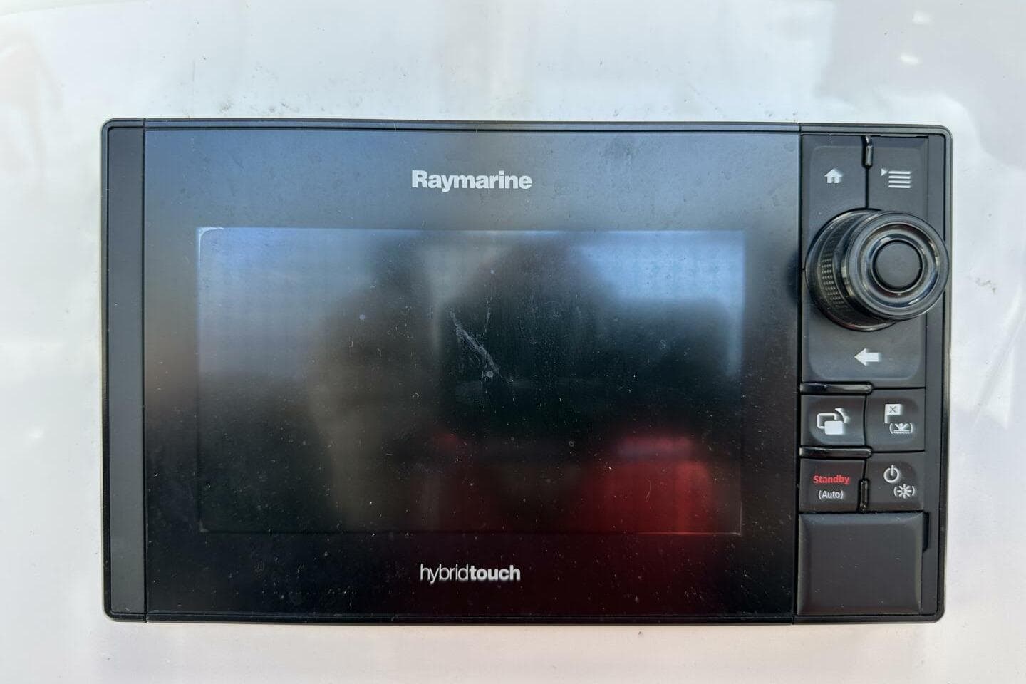 Raymarine HybridTouch display on Hughes 3910, 1979 model, featuring navigation controls.