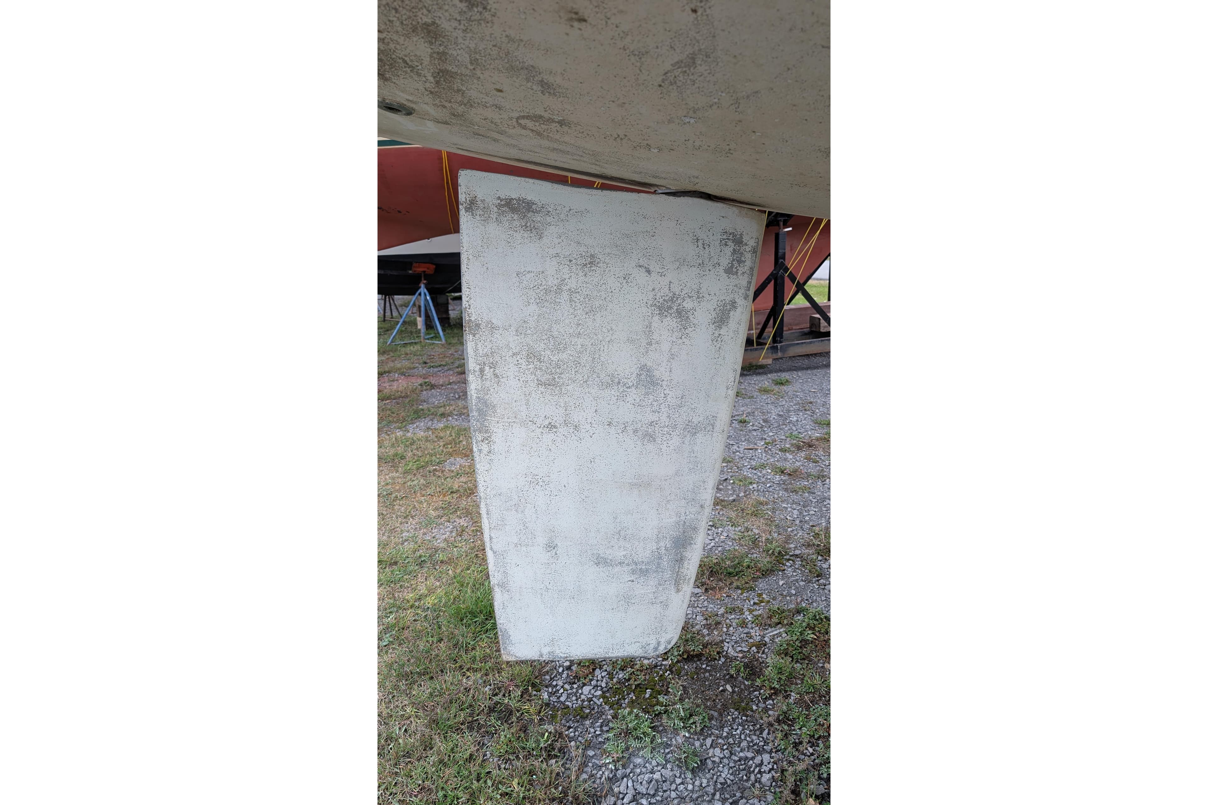 Keel of 2002 Hunter 326 sailboat on dry land, showing wear and texture.