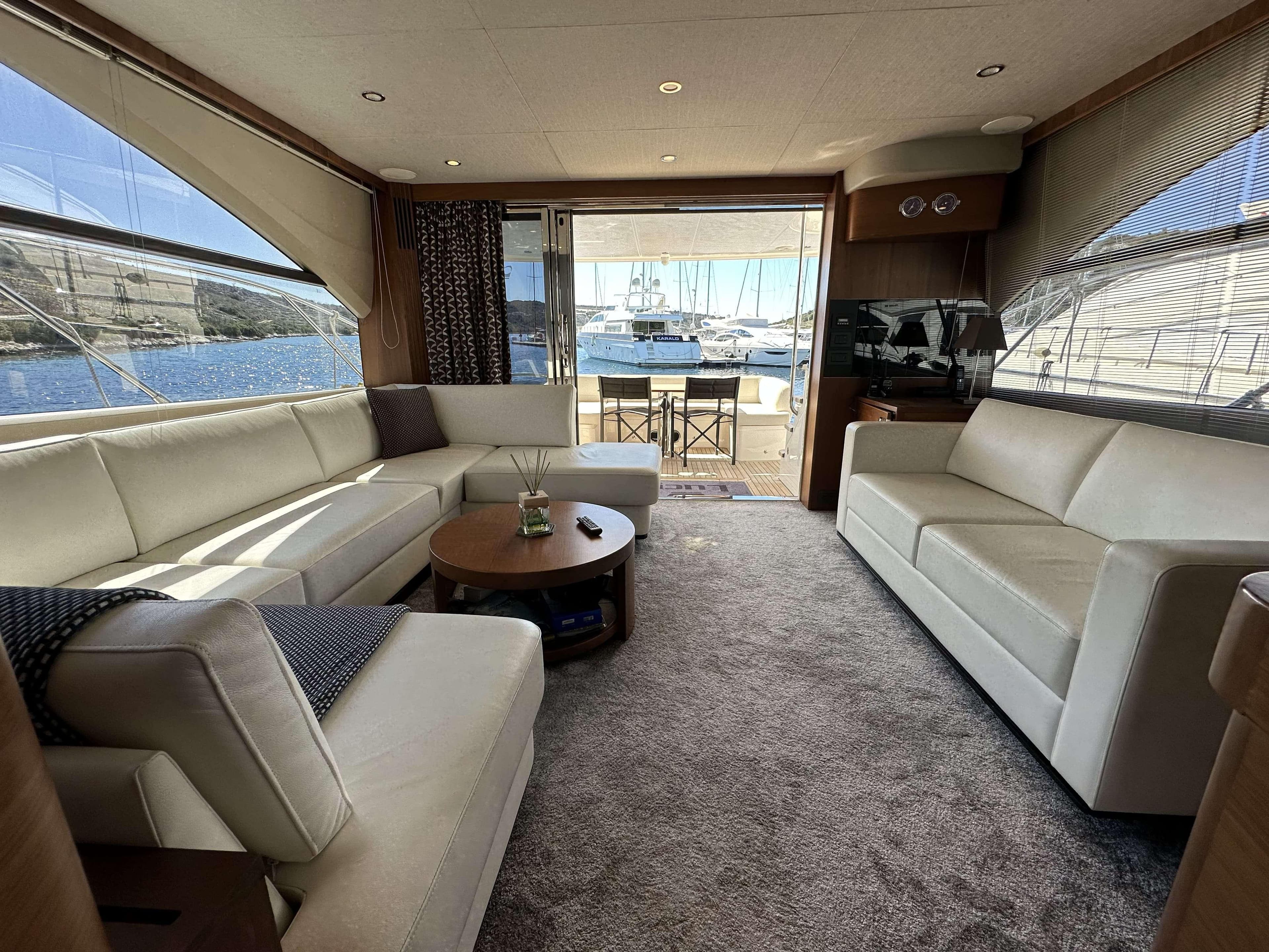 Luxurious interior of 2014 Princess 60 yacht with elegant seating and scenic ocean view.