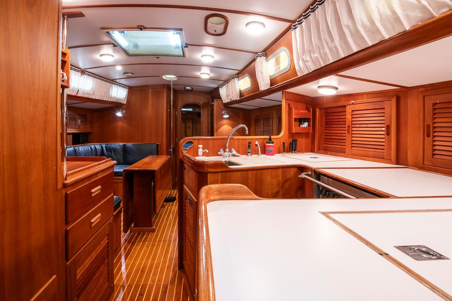 Luxurious interior of a 1993 Hinckley Sou'wester 51 yacht with wooden finishes and modern amenities.