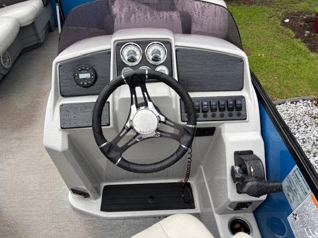 2021 Sylvan Mirage 820 Cruise dashboard with steering wheel and control panel.
