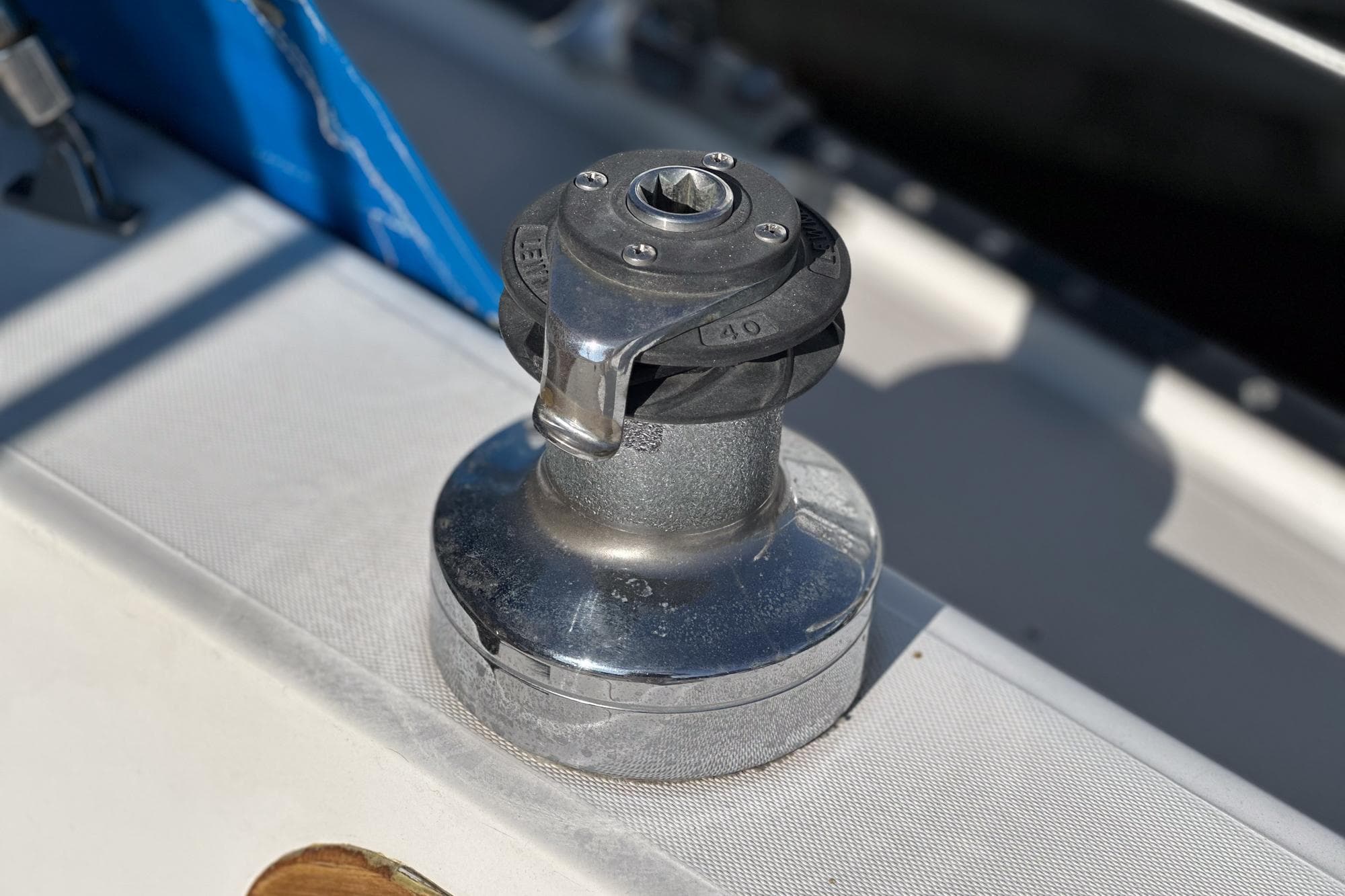 Winch on 1984 Catalina 30 sailboat deck, used for sail handling.