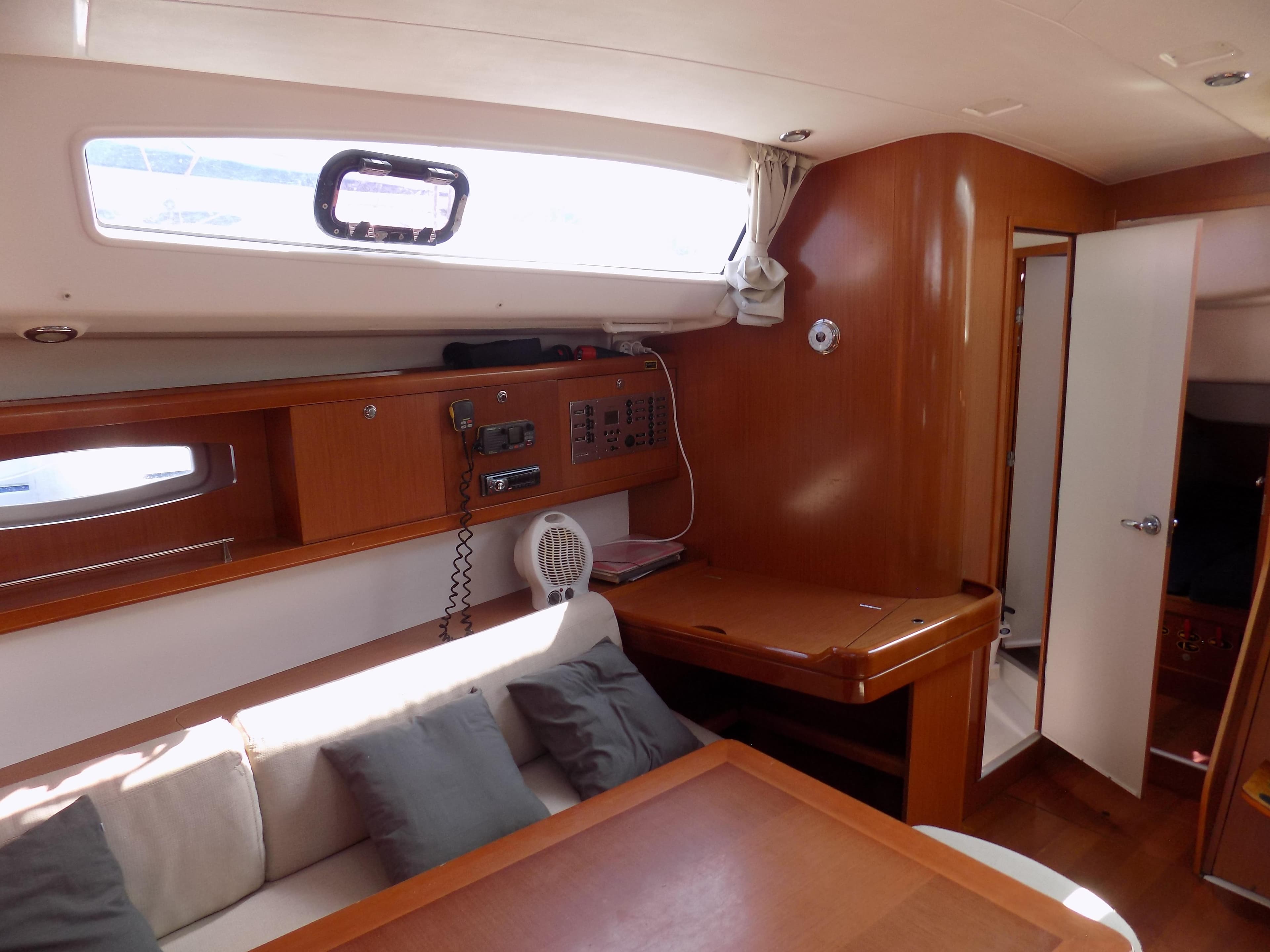 Interior of 2009 Beneteau Oceanis 43 sailboat with wood finish and seating area.