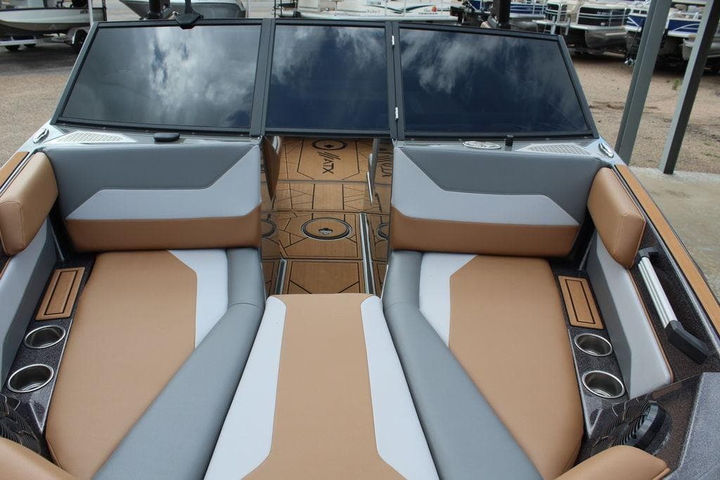 2024 ATX Surf Boats 22 Type-S interior with tan and gray seating, cup holders, and sleek design.