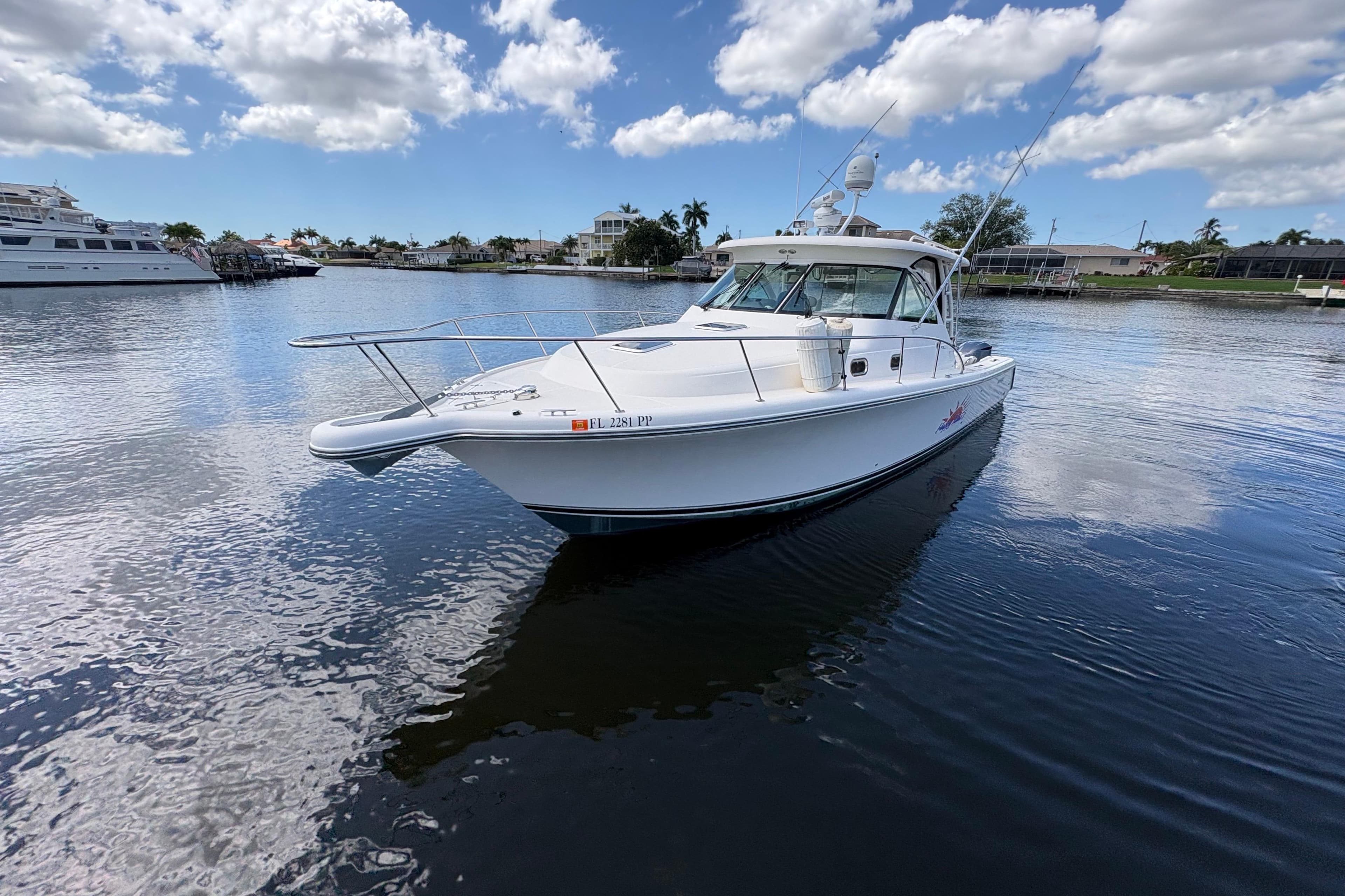 2011 Pursuit OS 375 Offshore boat on calm water under a partly cloudy sky.