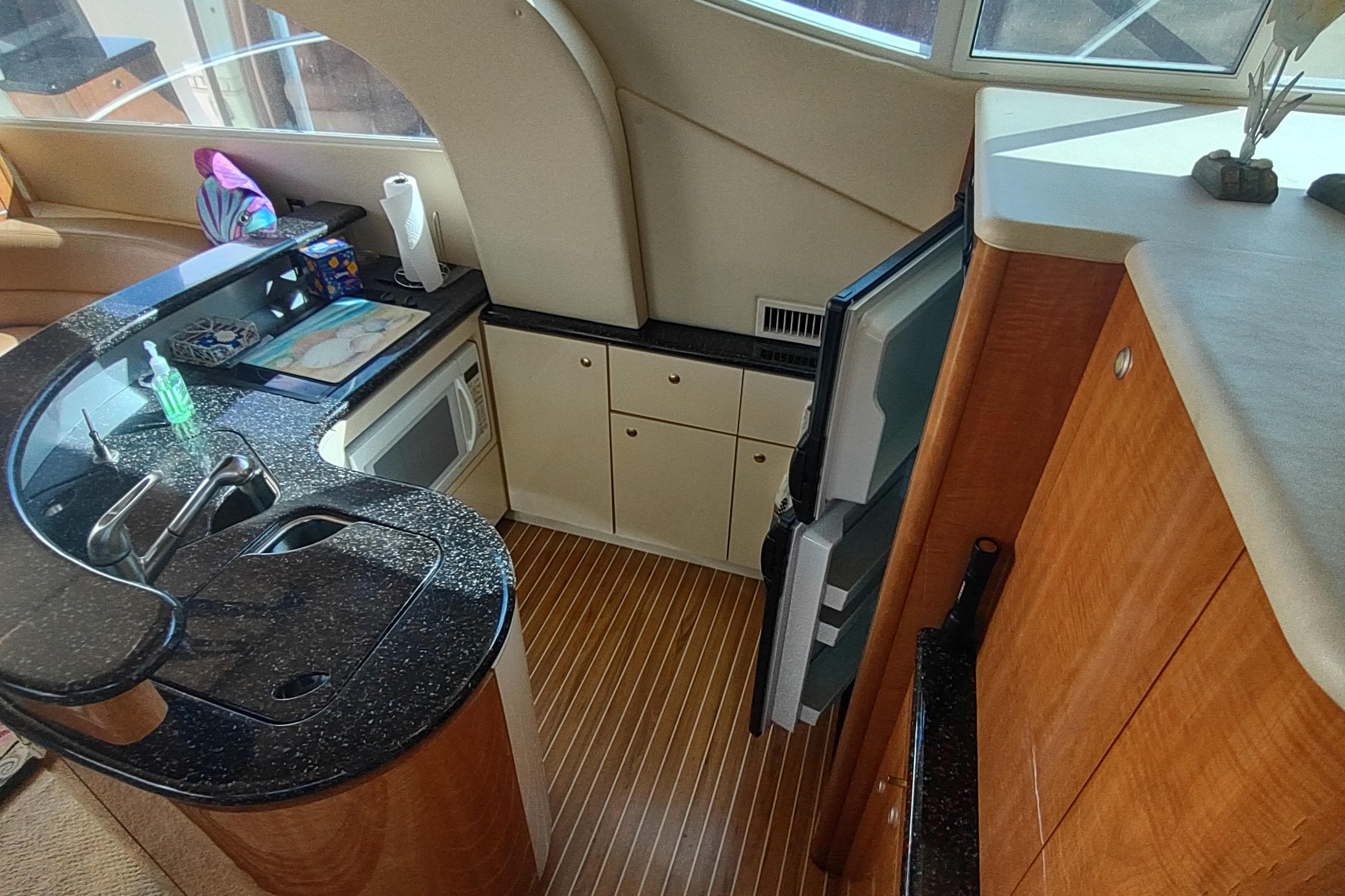 Luxurious kitchen interior of 2001 Maxum 4600 SCB yacht with modern amenities.