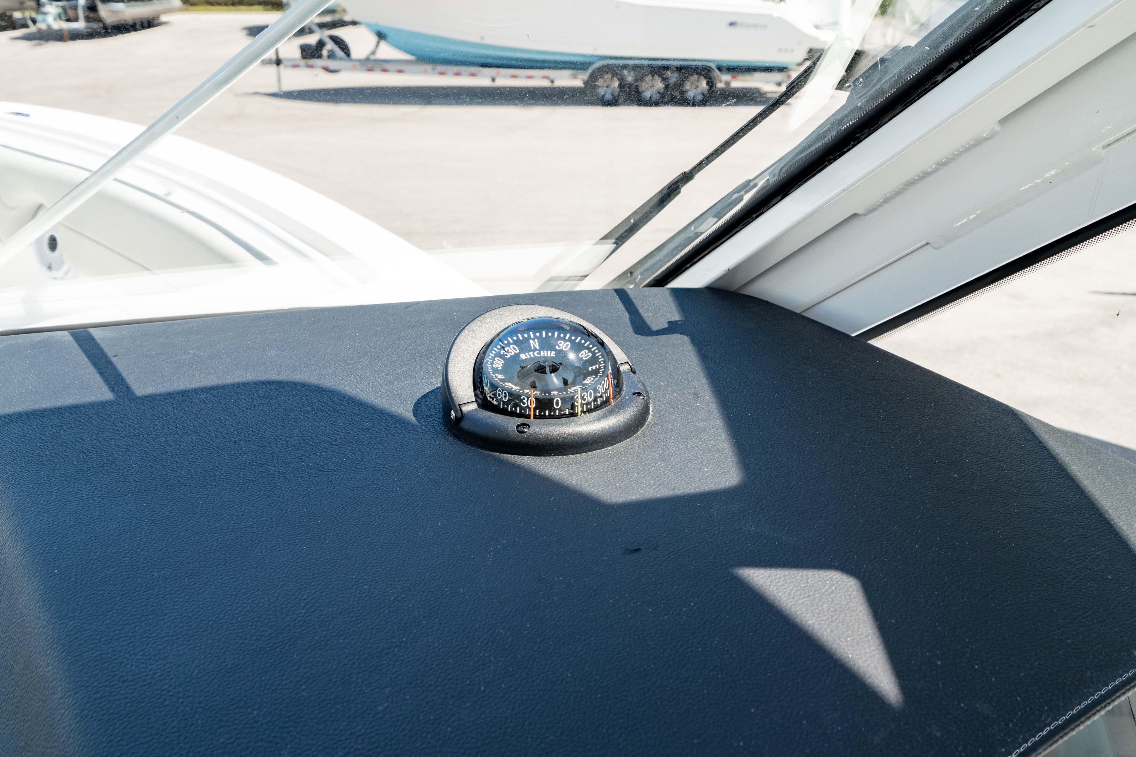 Compass on the dashboard of a 2026 Edgewater 262CX Crossover boat.