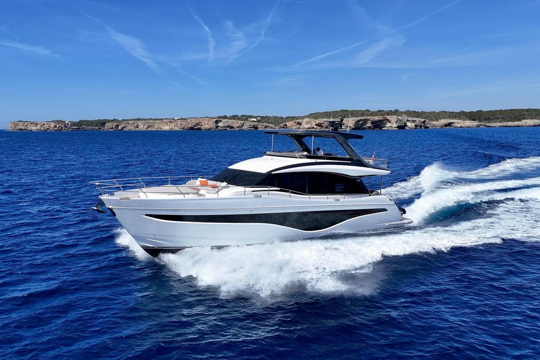 Luxurious 2025 Princess Y72 yacht cruising on vibrant blue ocean waters.