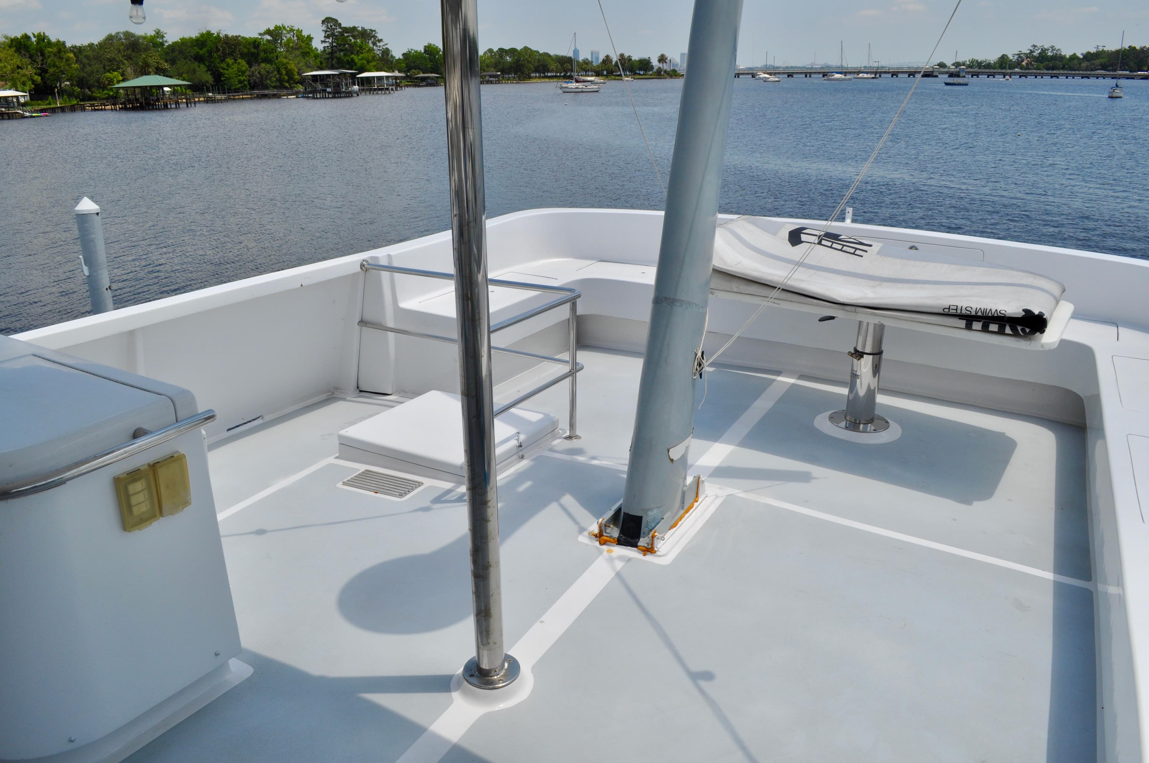 Upper deck of 1971 Custom Superior Motor Yacht 64, overlooking serene waters.