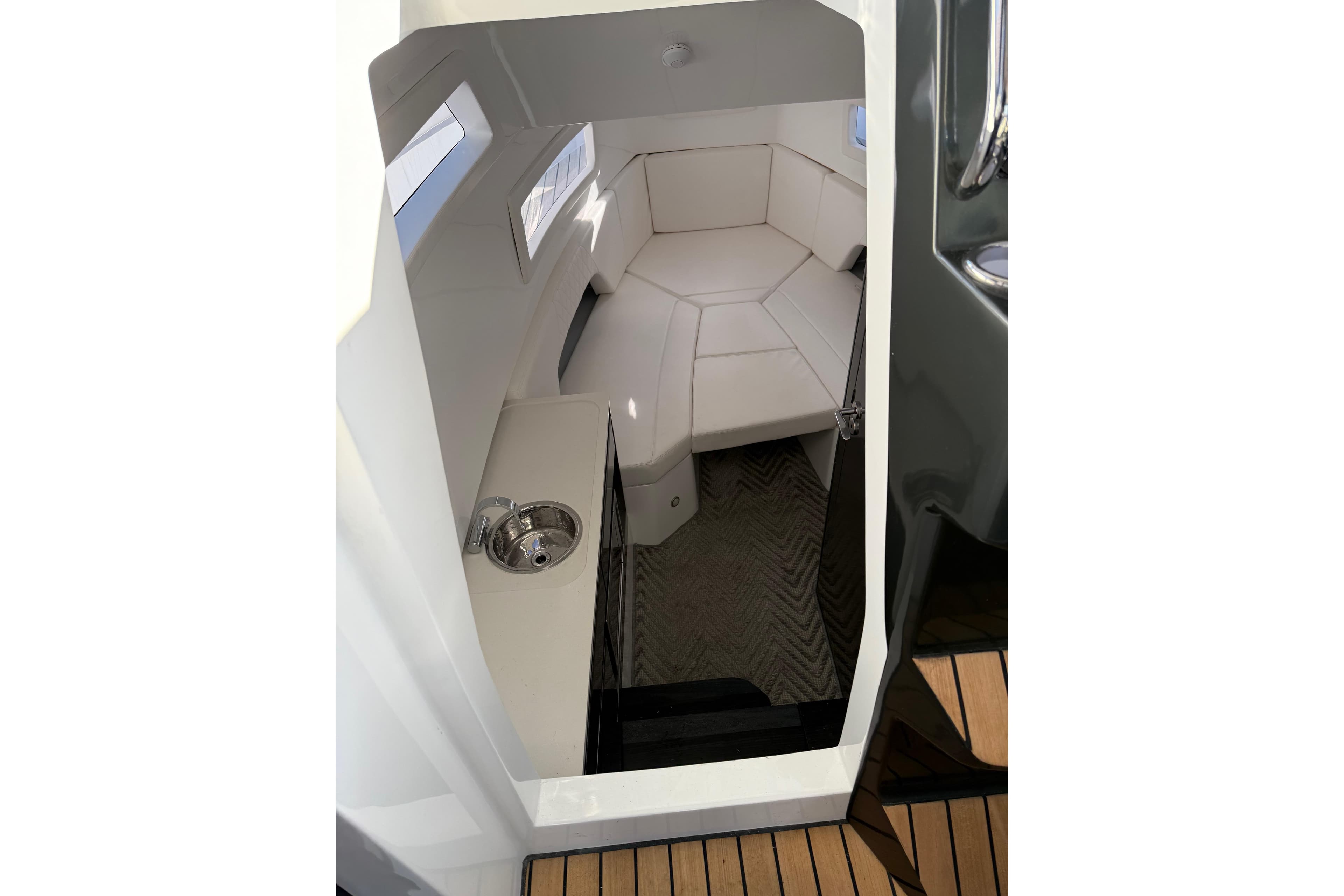 2024 Schaefer V33 cabin interior with white seating and compact sink.