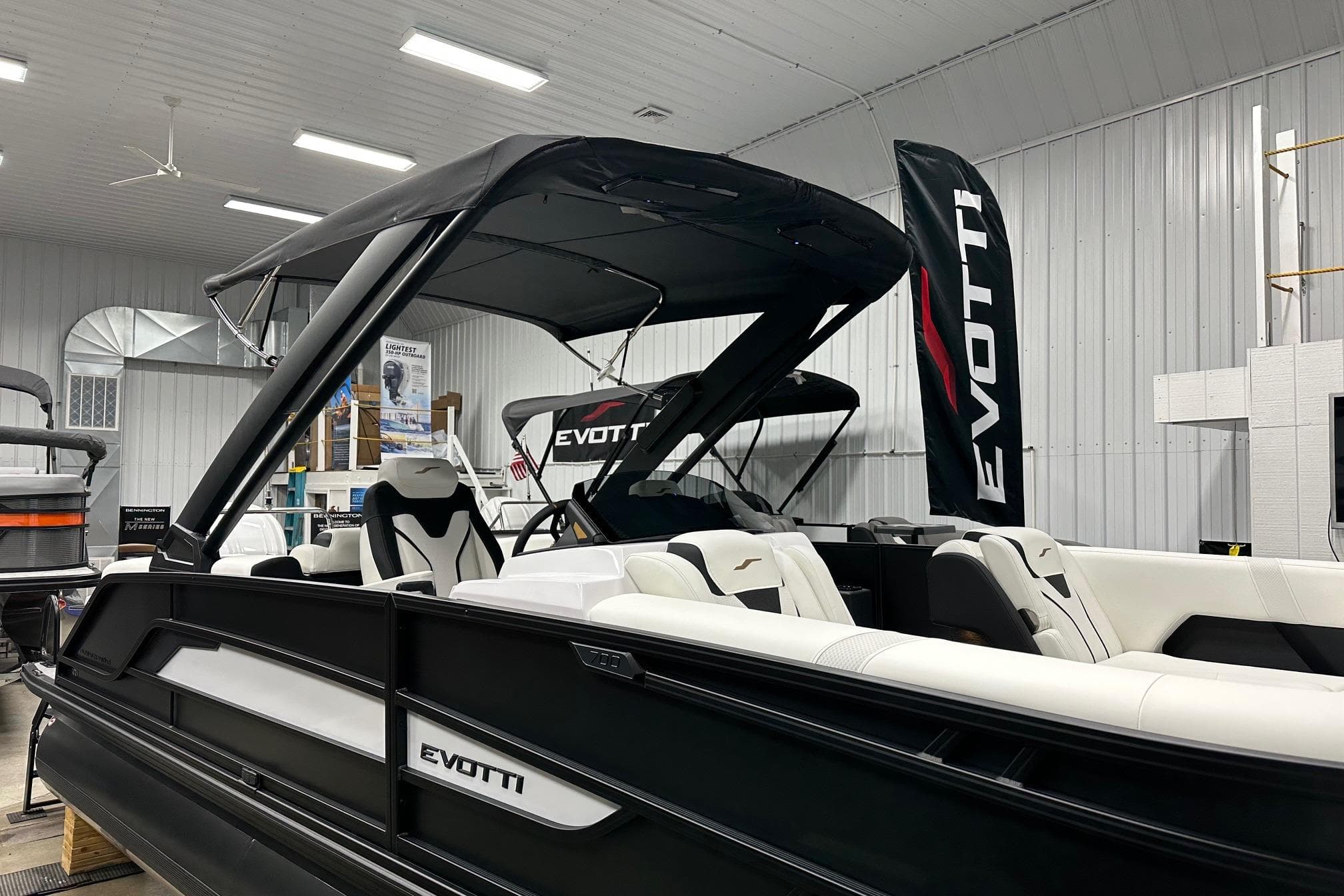2026 Evotti 723QL luxury boat in showroom with sleek black and white design.