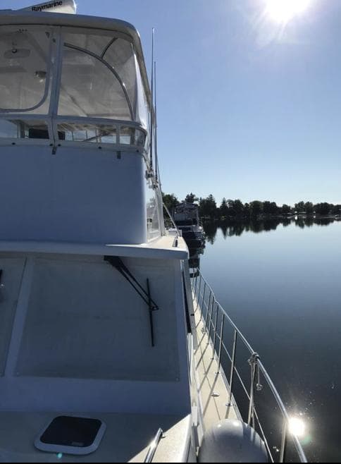 2007 Duffy Aft Cabin boat on calm water under clear sky.