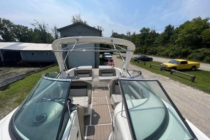 2012 Sea Ray 300 SLX boat with spacious seating and sleek design, parked outdoors.