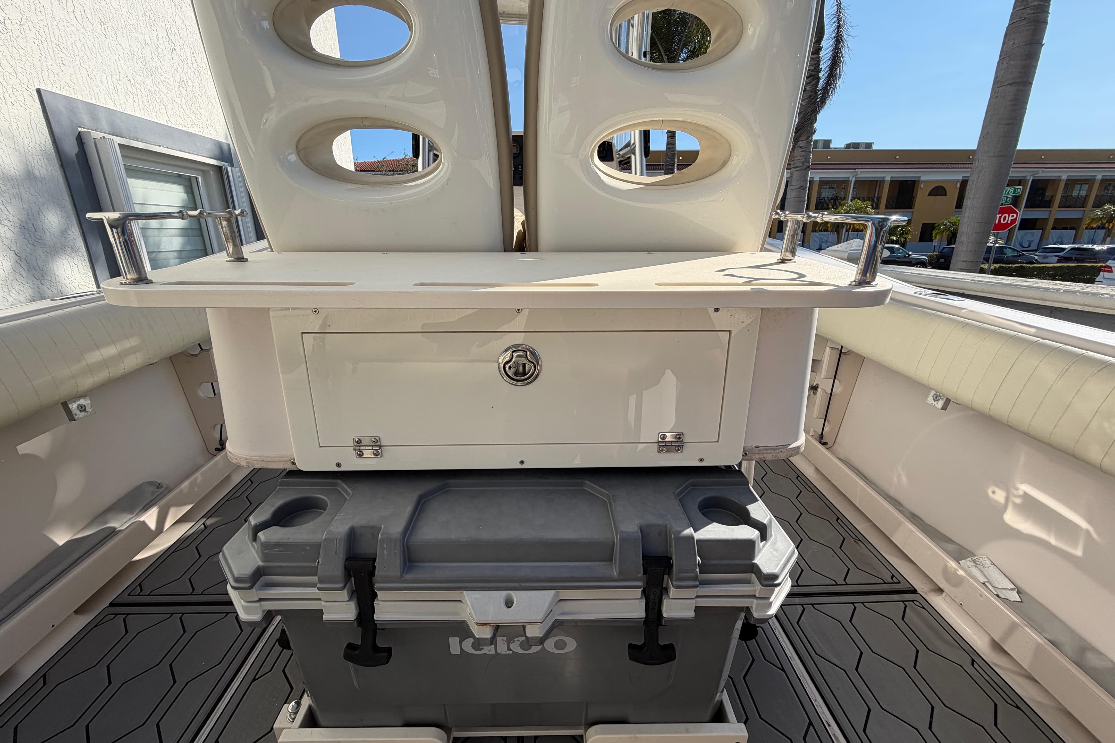 2004 Grady White 273 boat interior with storage and cooler, featuring rod holders.