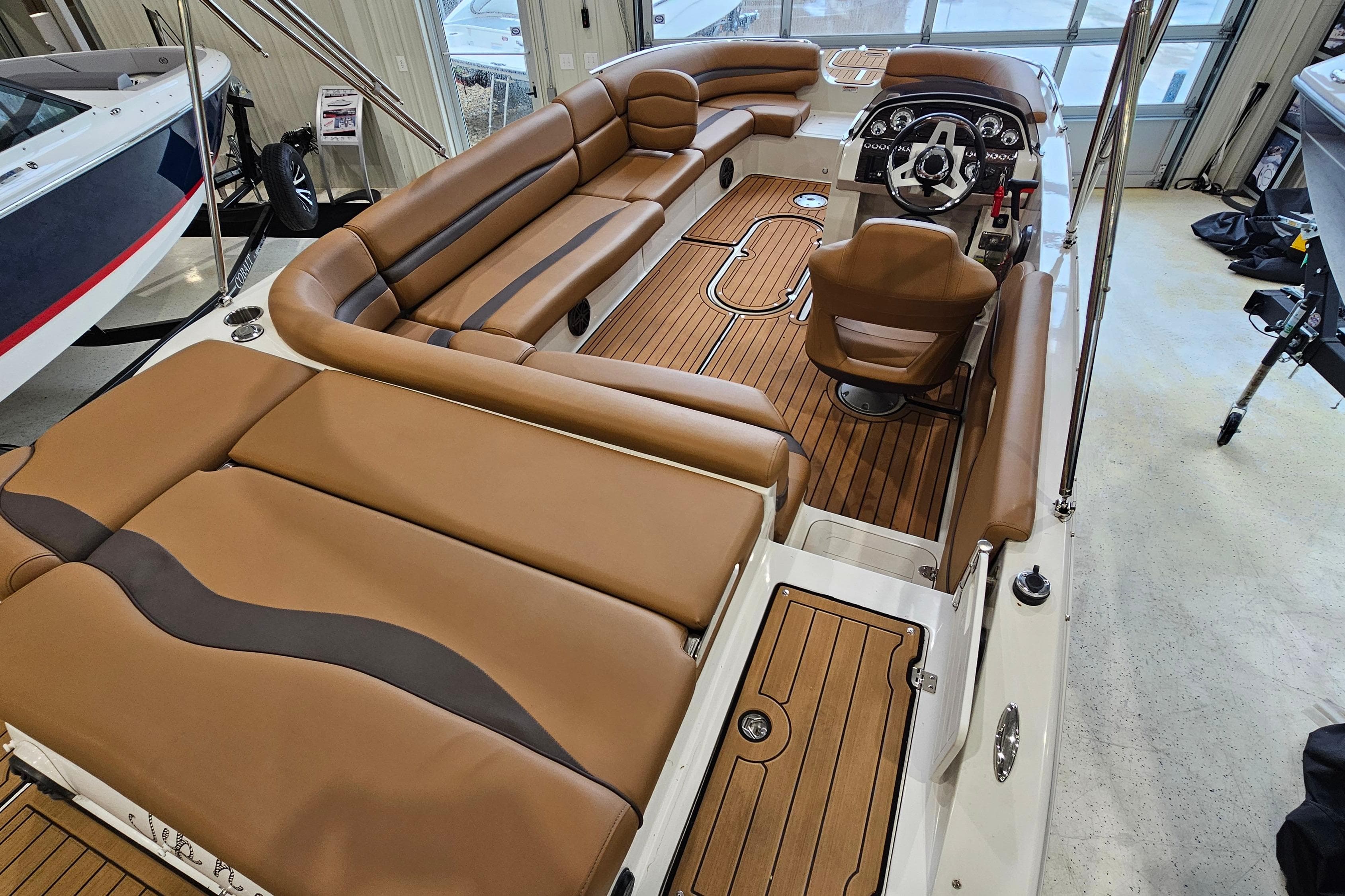 2022 Starcraft Star Step 221 E I/O boat interior with brown seating and wood flooring.