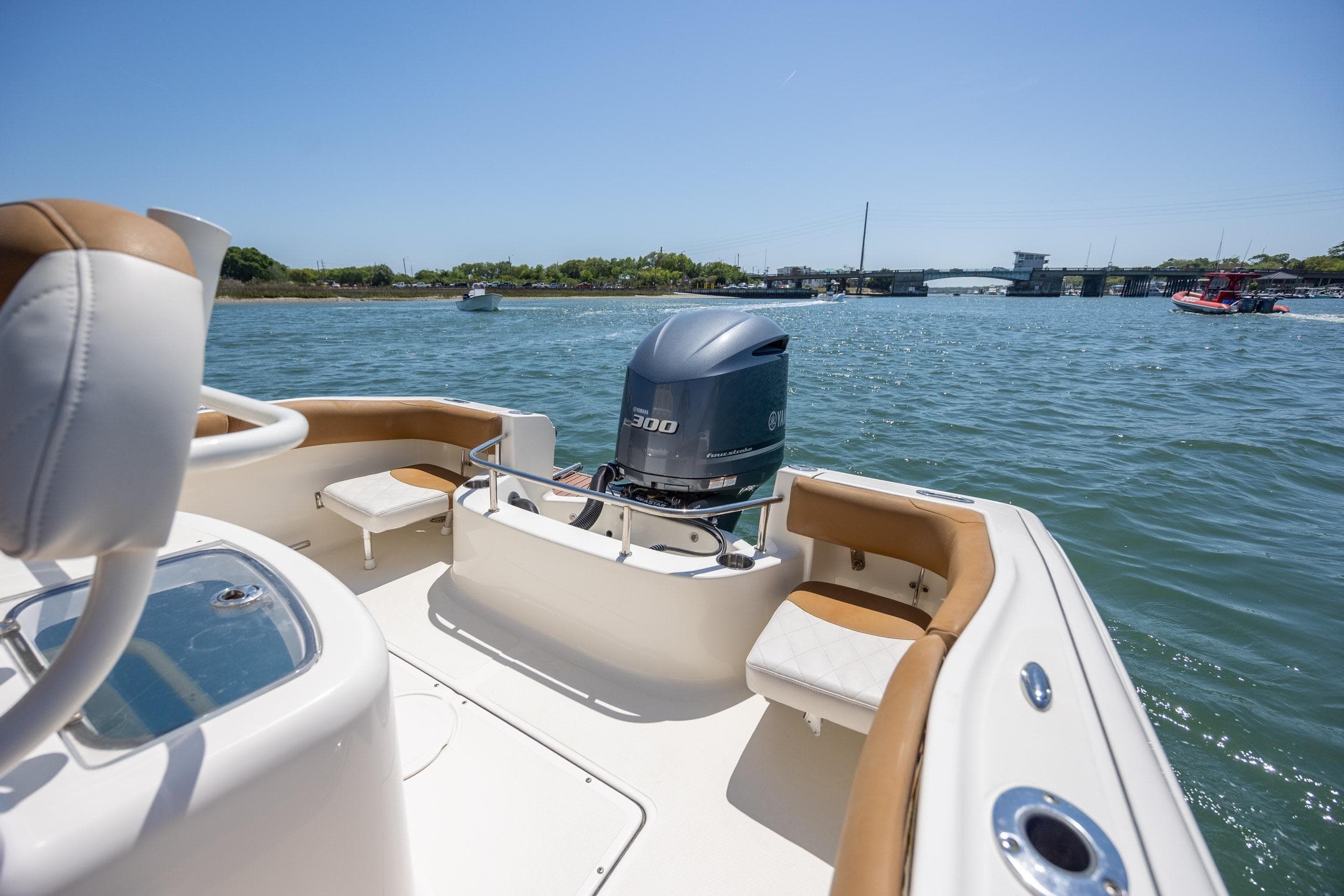 2019 Pioneer 222 Sportfish boat on water, featuring a powerful outboard motor.