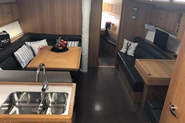 Luxurious interior of a 2012 Solaris 48 yacht with modern kitchen and seating area.