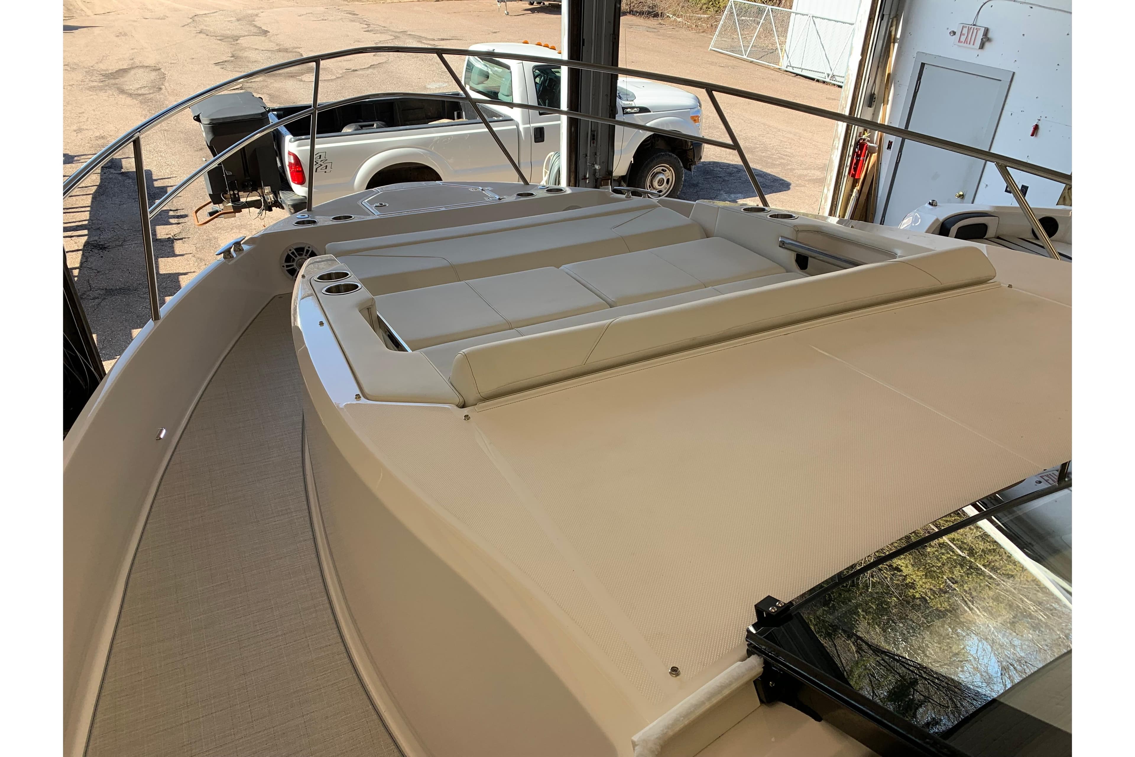 2024 Regal 36 Grande Coupe boat deck with seating area, parked in a garage.