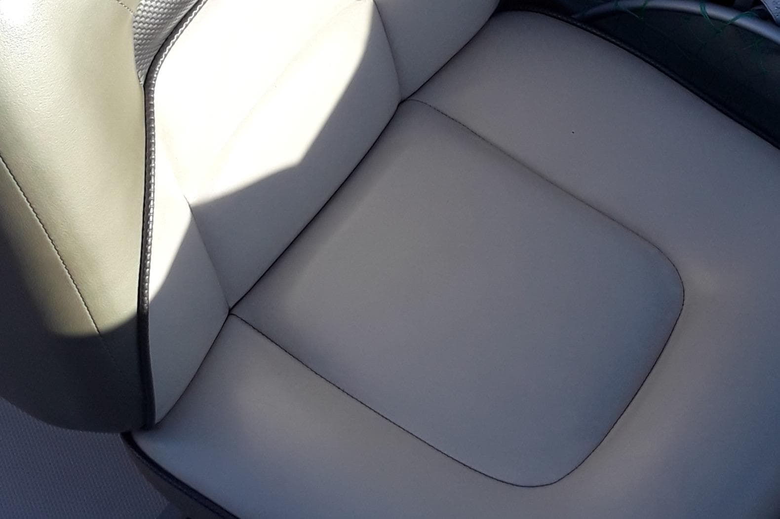 Close-up of a 2005 Sea Ray 200 SLX boat seat in beige upholstery.