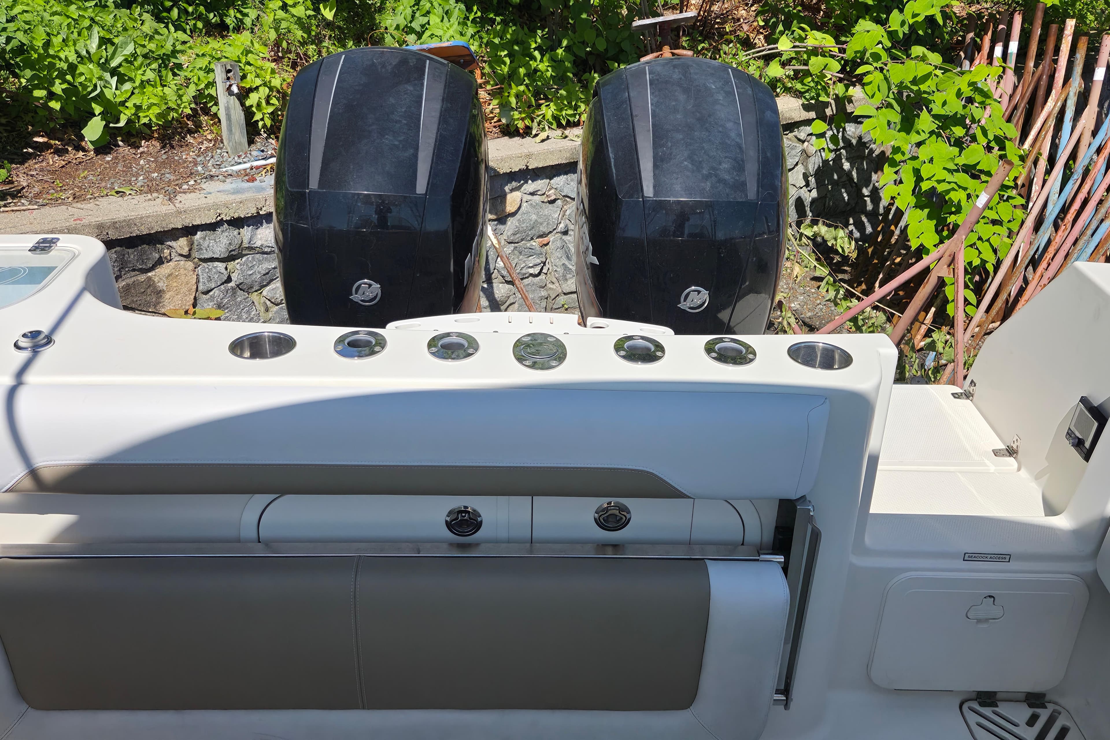 2016 Sailfish 275 DC boat with dual outboard motors and cockpit seating.